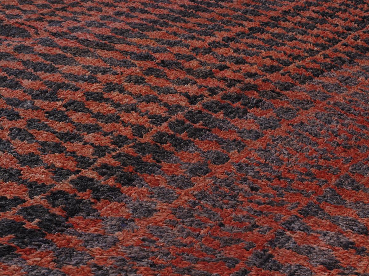 This Vintage Moroccan Berber hand-knotted wool rug is hand-carded with all natural dyes in black and red. Selectively curated from thousands of pieces, our Moroccan Collection represents the most unique styles from the Atlas Mountain region. From