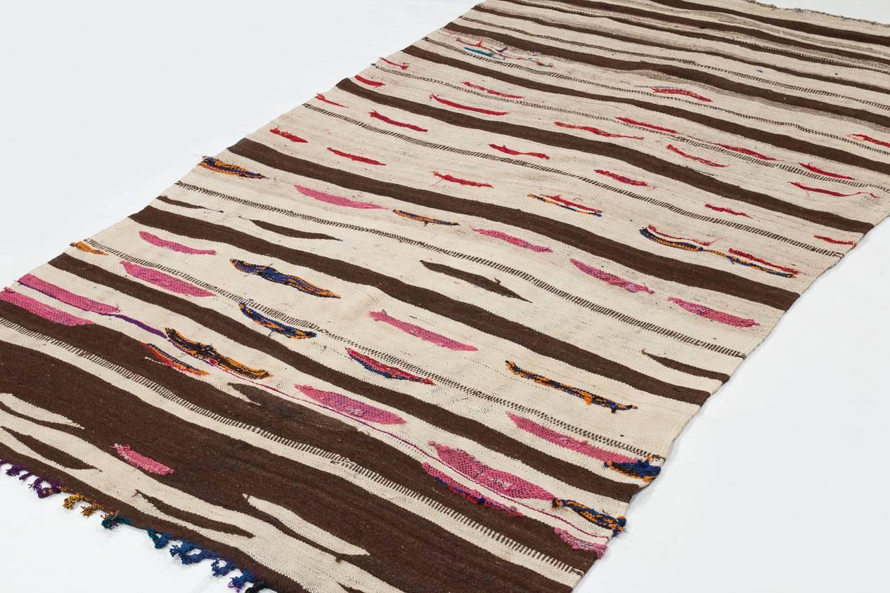 Made from thick, silky wool, this vintage Kilim is so sit and pliable that it could also be used as a blanket. Measures: 4'3” x 7'8”.