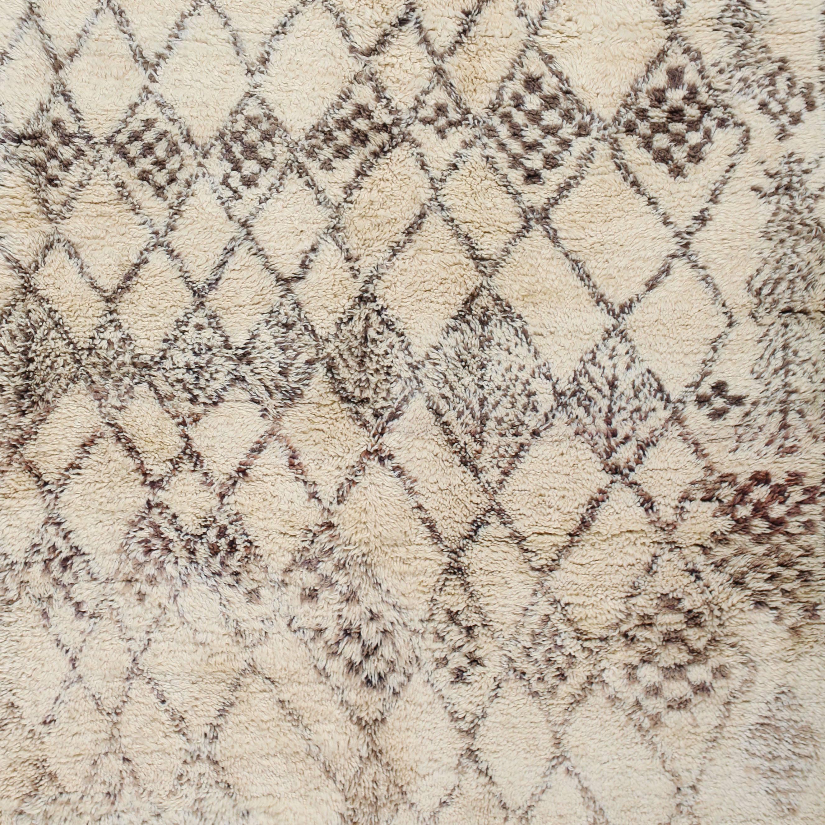 Welcome to the metaphysical world of Beni Ouarain weavers.
This authentic Berber carpet with a biomorphic pattern is hand-knotted with a soft blend of subtle browns on a field of natural golden-white wool. The Beni Ouarain tribe produces some of the