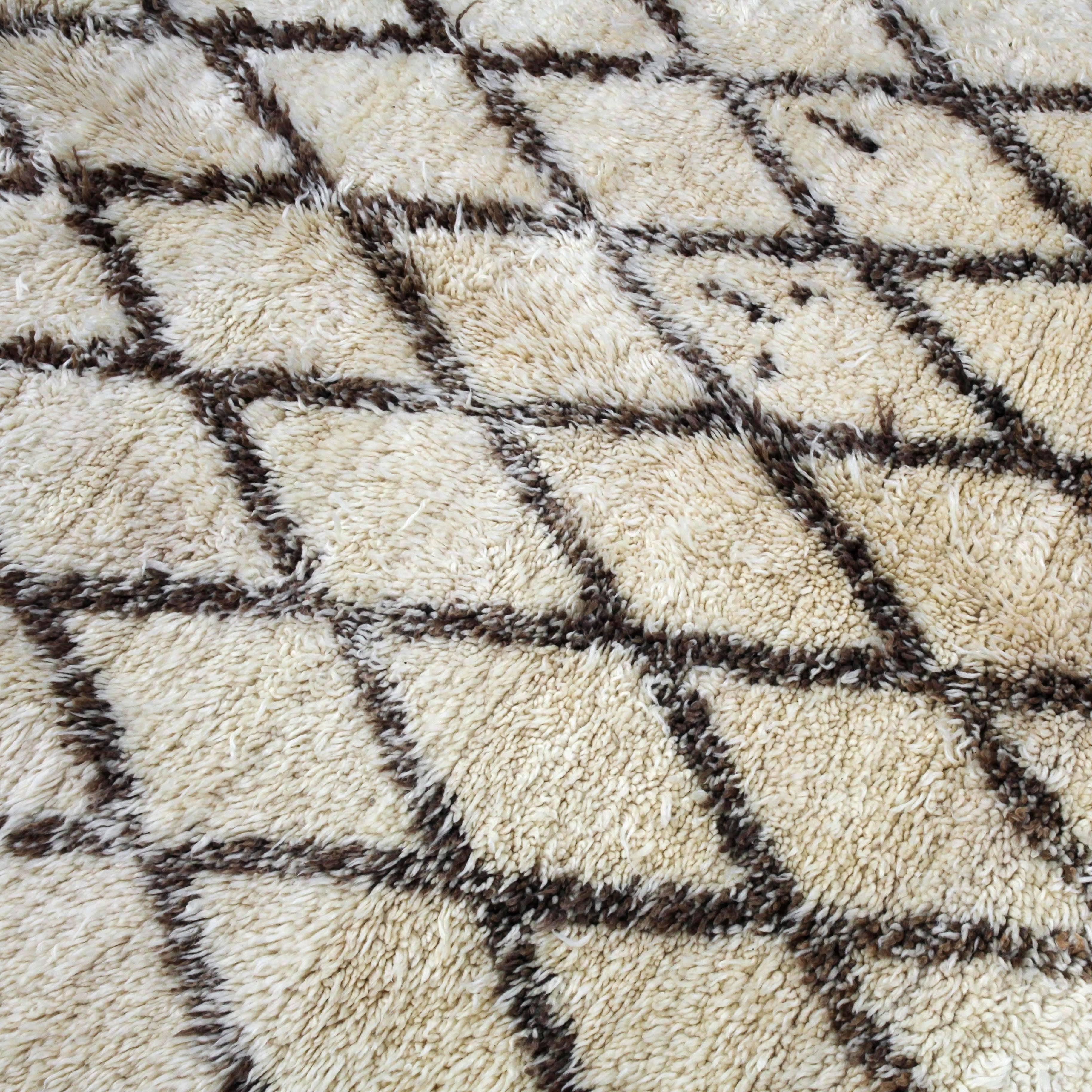 A wonderful array of subtle browns set the mood for this traditional tribal pattern. The Beni Ouarain tribe produces some of the finest quality rugs in all of Morocco. Usually made of natural ivory and black or brown wool as the pattern, these rugs