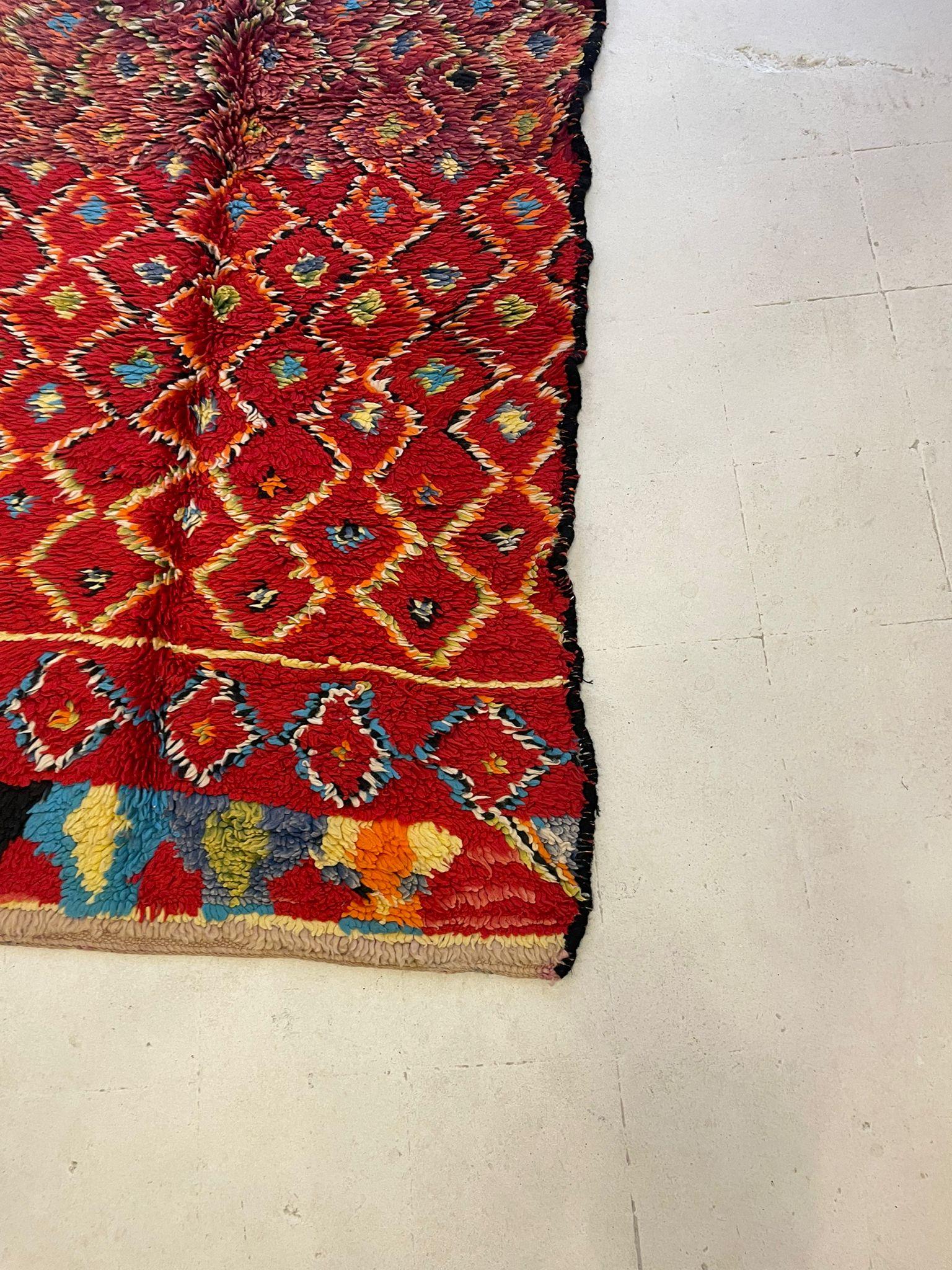 An exuberant example of Moroccan folk artistry, this vintage Boucherouite rug offers a joyful composition of vibrant color, texture, and symbolism. Woven in the High Atlas Mountains by Berber women in the 1970's, the rug is crafted using wool.

The