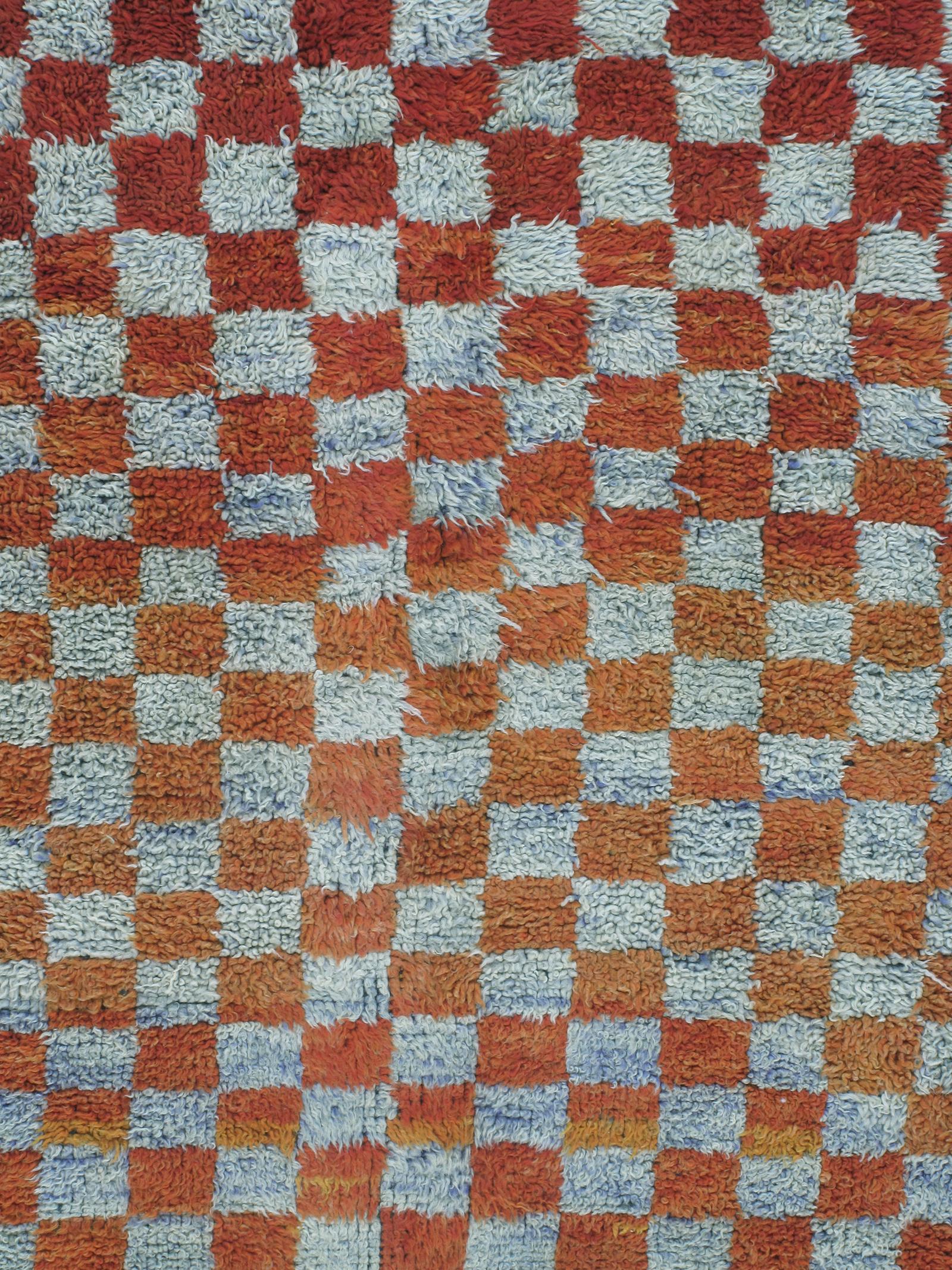 Vintage Moroccan Boujad Berber Tribal rug with a Checkered Design
Our vintage Moroccan rugs are part of a skillfully curated collection of rare and unusual designs. They are made of all-natural dyes and 100% handspun wool from the Atlas Mountain