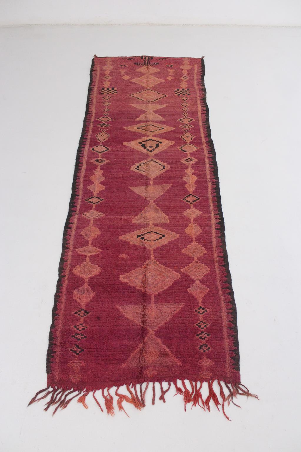 This real vintage runner rug was probably made in the Boujad region, North Morocco. It is a crazy beautiful, very elegant piece with lovely designs -the traditional diamond series- and such a deep color!

Background color is a 