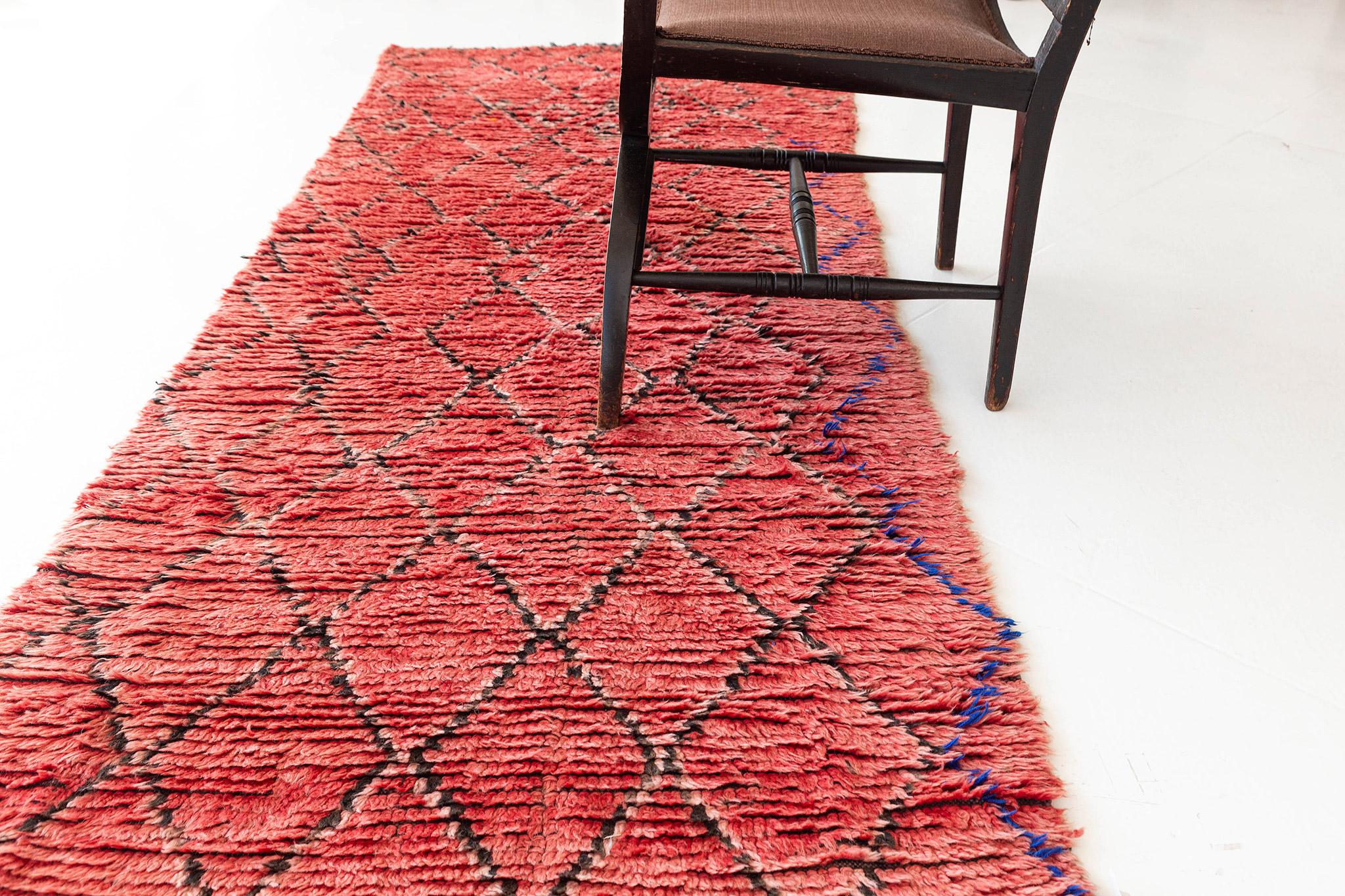 Deep coral red pile field with a lattice pattern in pink and gray with incidents of brilliant blue. A vivid vintage piece from the Boujad region of Morocco. 