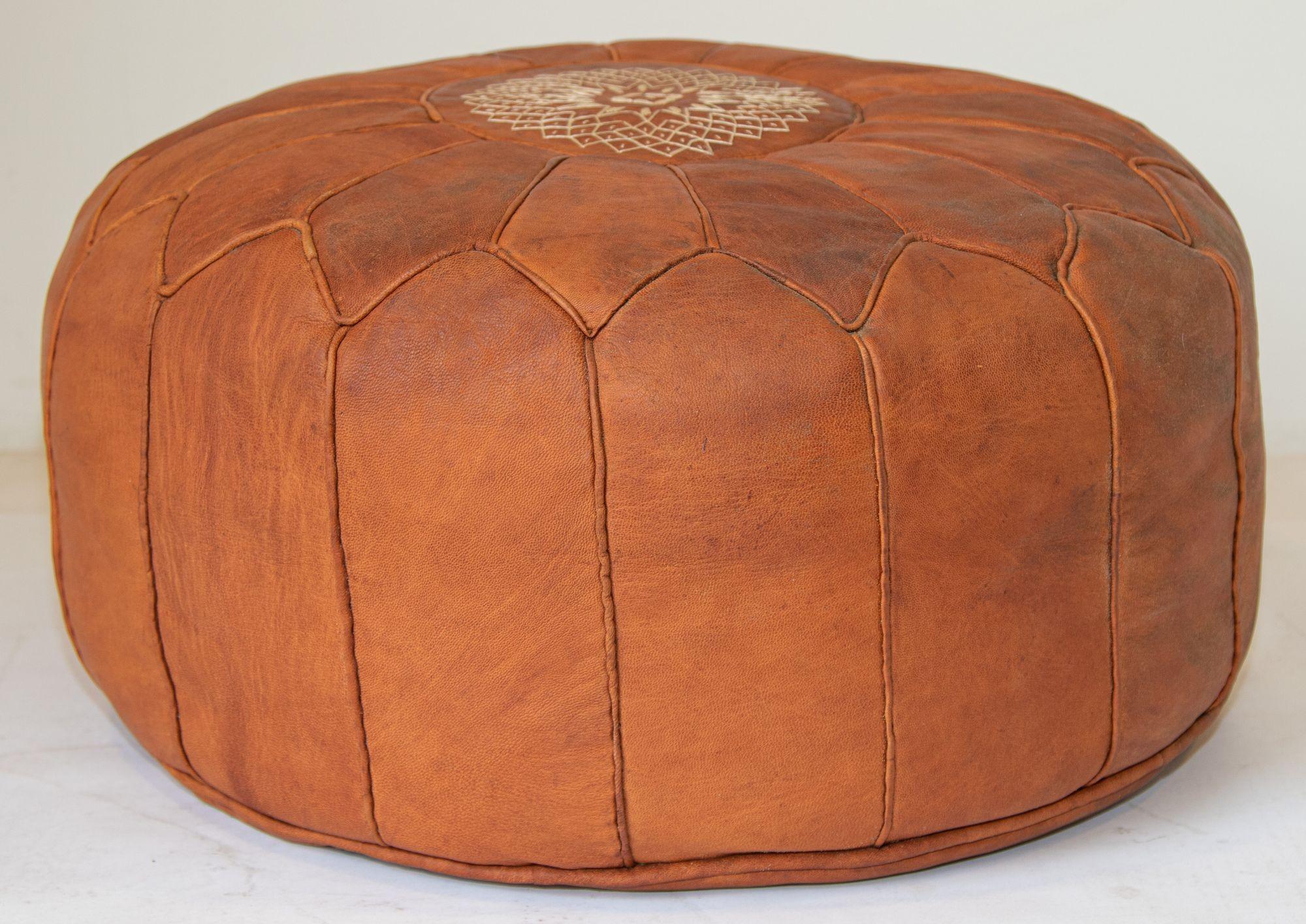 Vintage Moroccan brown leather pouf.
Large vintage round Moroccan leather pouf, handcrafted in brown camel leather.
Hand tooled Moroccan leather ottoman embroidered on top with a Moorish design by Moroccan artisans in Marrakech.
Multiple