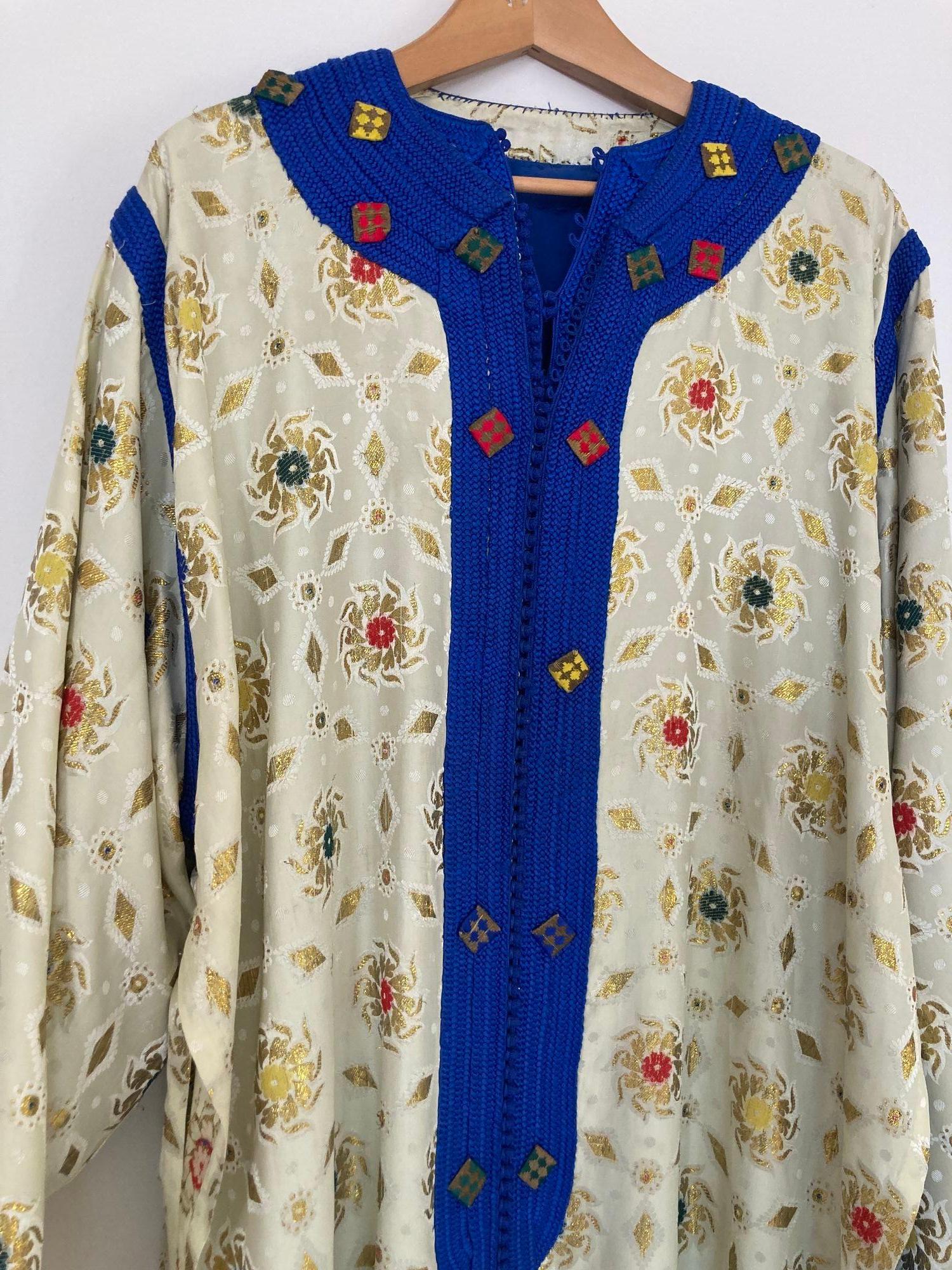 Elegant Moroccan caftan in Royal blue and gold embroidered trim,
circa 1970s.
This long maxi dress kaftan is embroidered and embellished entirely by hand.
It’s crafted in Morocco and tailored for a relaxed fit.
One of a kind evening Moroccan Middle