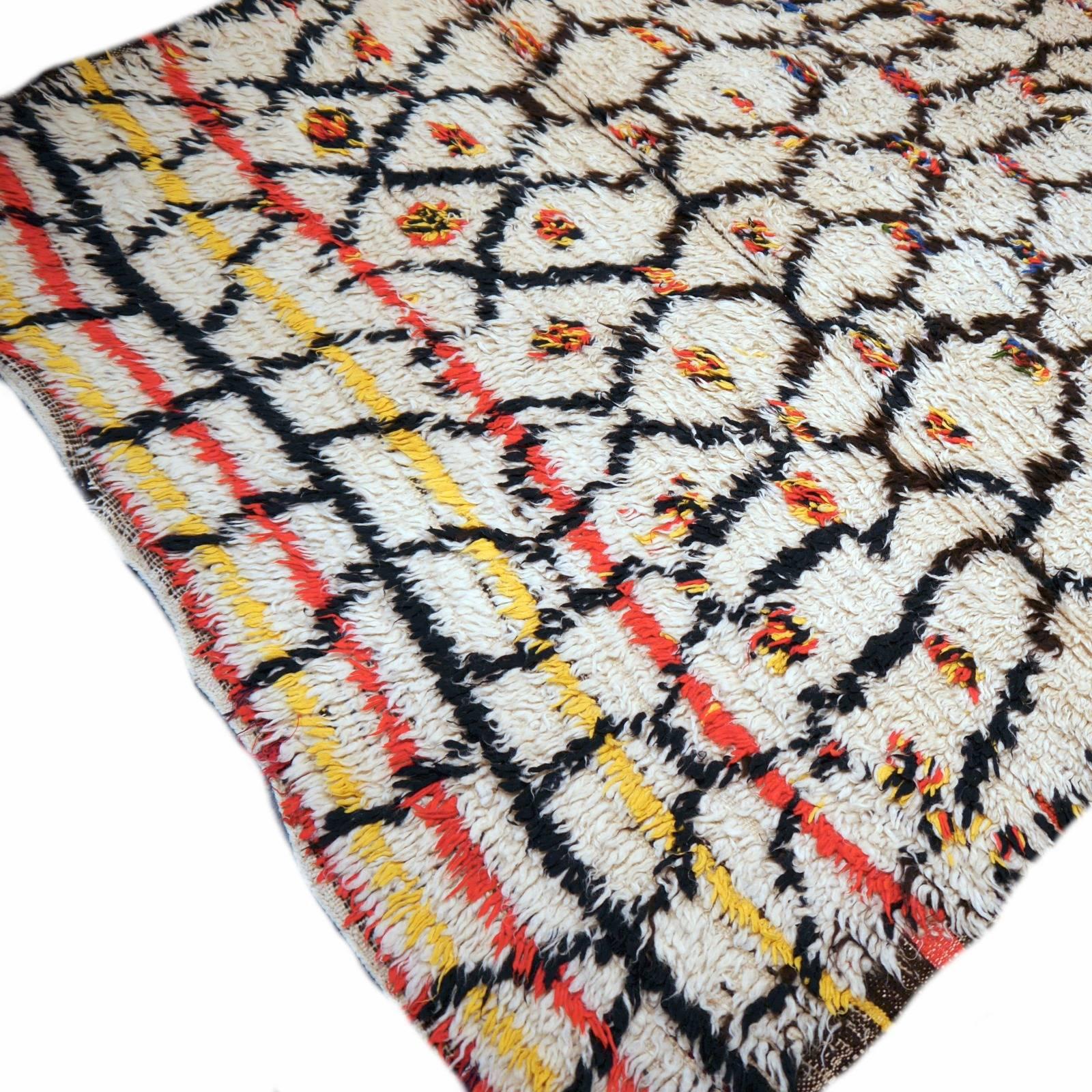 Very beautiful vintage Moroccan tribal carpet. Hand knotted by tribal women in the Moroccan mountains. Joyful colors and design.

The Djoharian Design Collection is located in Germany, all our rugs are shipped from there. We are licensed FAIR-TRADE