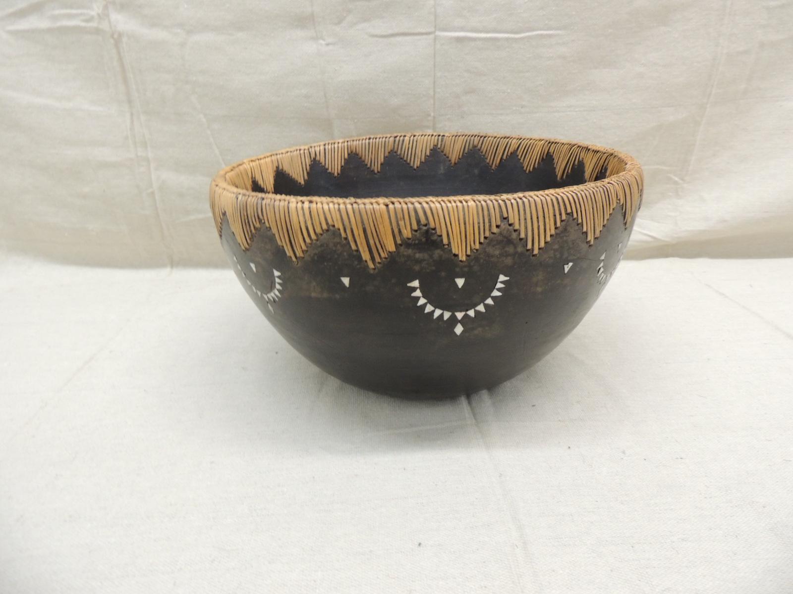 Vintage Asian carved wood bowl
with rattan details and mother of pearl inlaid embellishments inside and around outer edges.
Size: 11.5