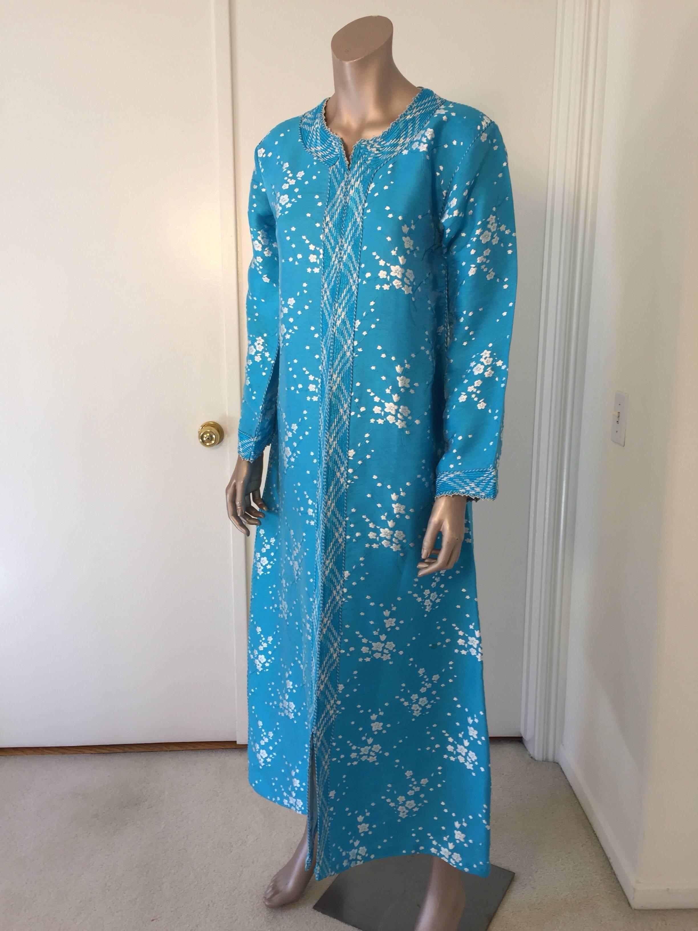 Elegant vintage designer Moroccan turquoise blue kaftan, embroidered with turquoise and white trim.
This chic Bohemian maxi dress kaftan is embroidered and embellished with a blue and white trim. 
One of a kind evening Moroccan Middle Eastern