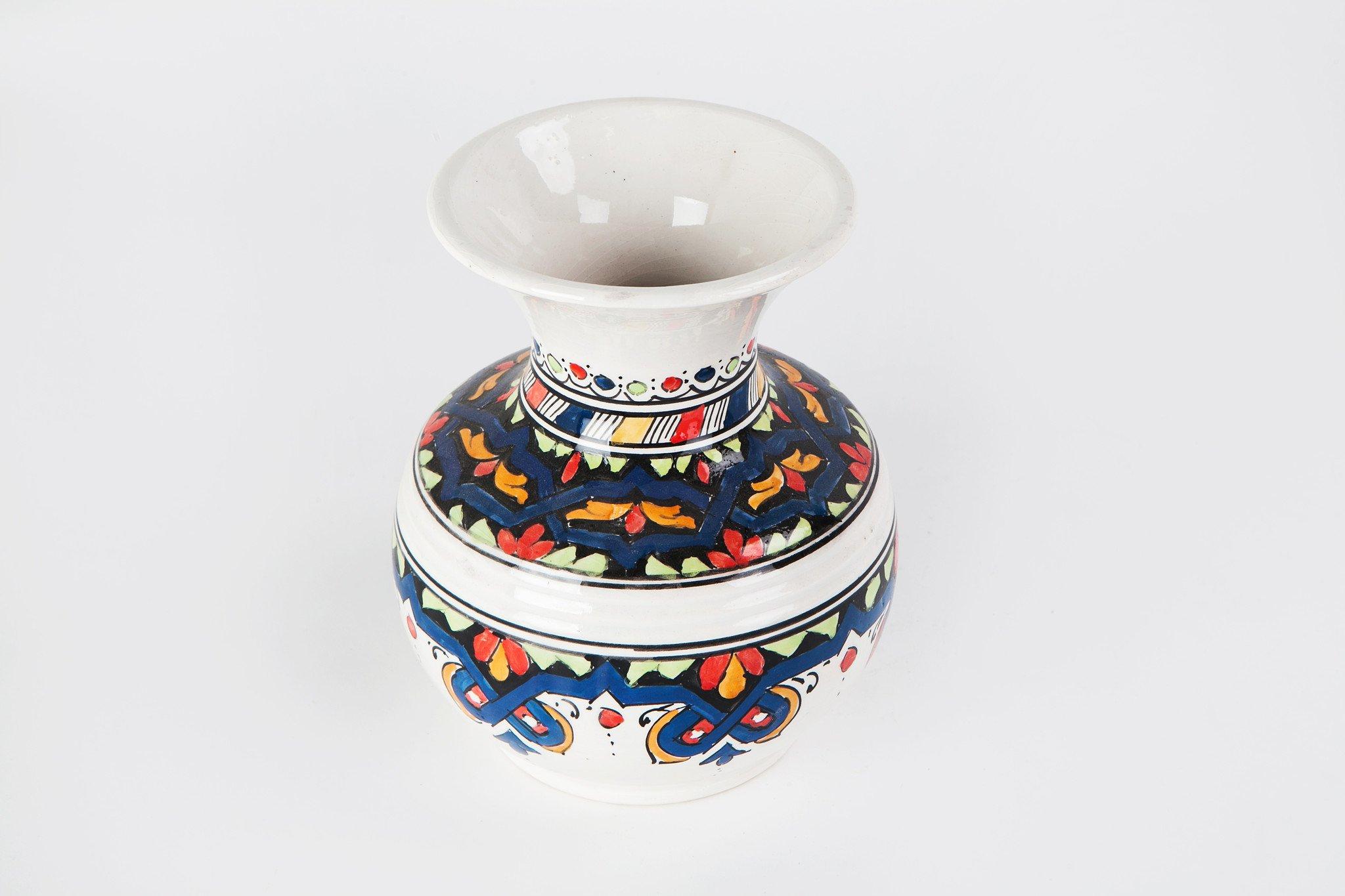 Featuring wonderfully intricate and lyrical hand painted designs, this bright, colorful ceramic vase provides a touch of exotic sophistication and soothing tranquility that will elevate the style of any room. It has been created by master artisans