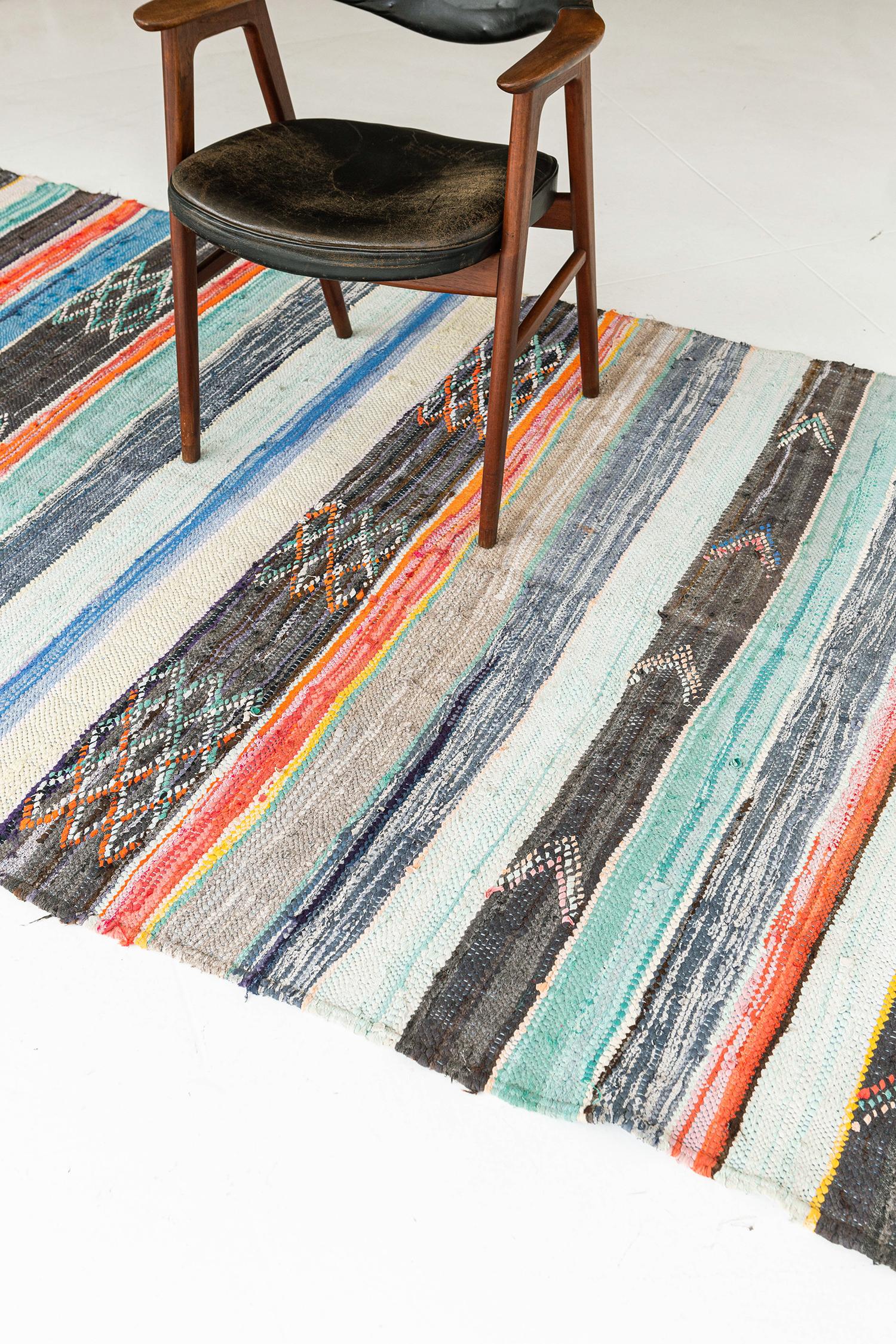 A creative vintage Moroccan rug Haouz tribe design from our Atlas collection that is knotted in shades of midcentury color scheme wool. It features a story of Haouz tribe with lozenges and chevrons. A centerpiece that is perfect with your living