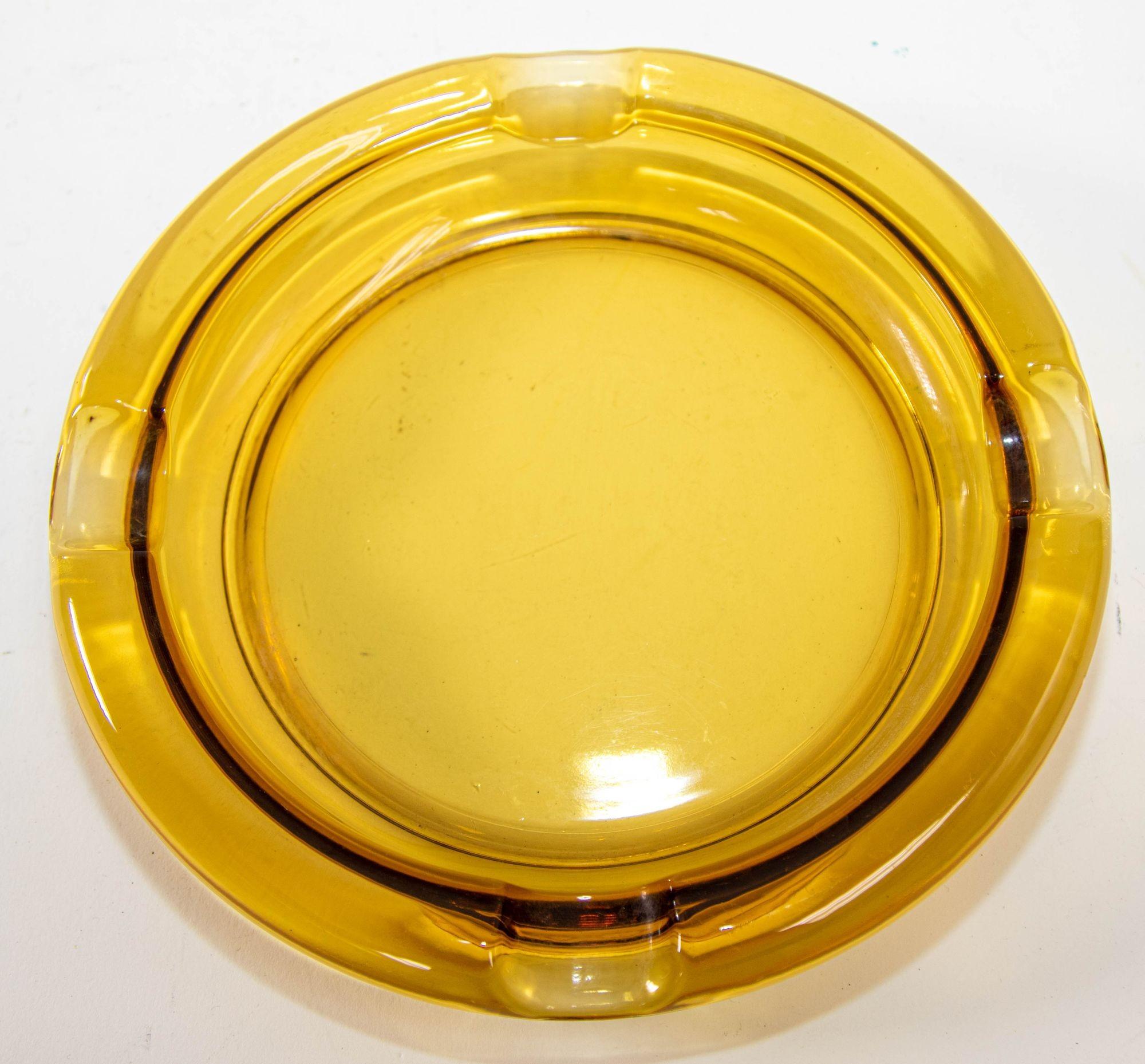 Large Moroccan amber glass ashtrays from the 1960s 1970s.
Vintage Hazel Atlas amber round circular form cigar ashtray.
Vintage hazel atlas Moroccan amber yellow glass ashtray, the color vary with light from yellow amber to dark honey amber.
In