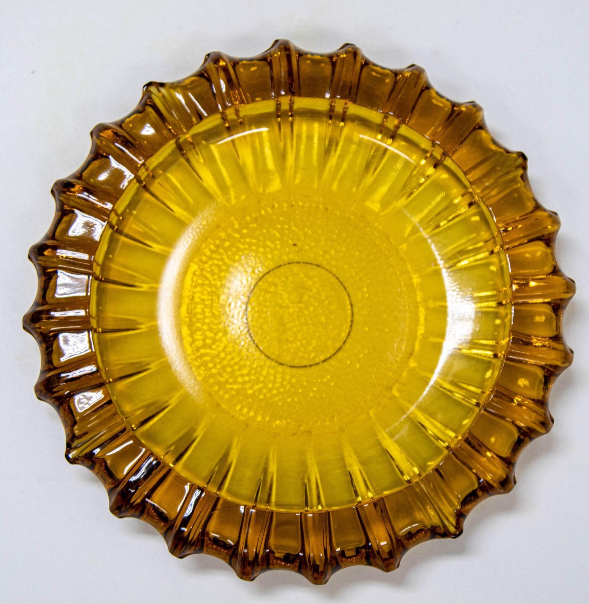 Vintage Mid-Century Modern Moroccan Hazel Atlas Round Amber Glass Cigar Ashtray.
Collectible Moroccan amber glass ashtray, catchall dish, center bowl from the 1950s.
Vintage Hazel Atlas amber round sunflower form cigar ashtray or decorative center