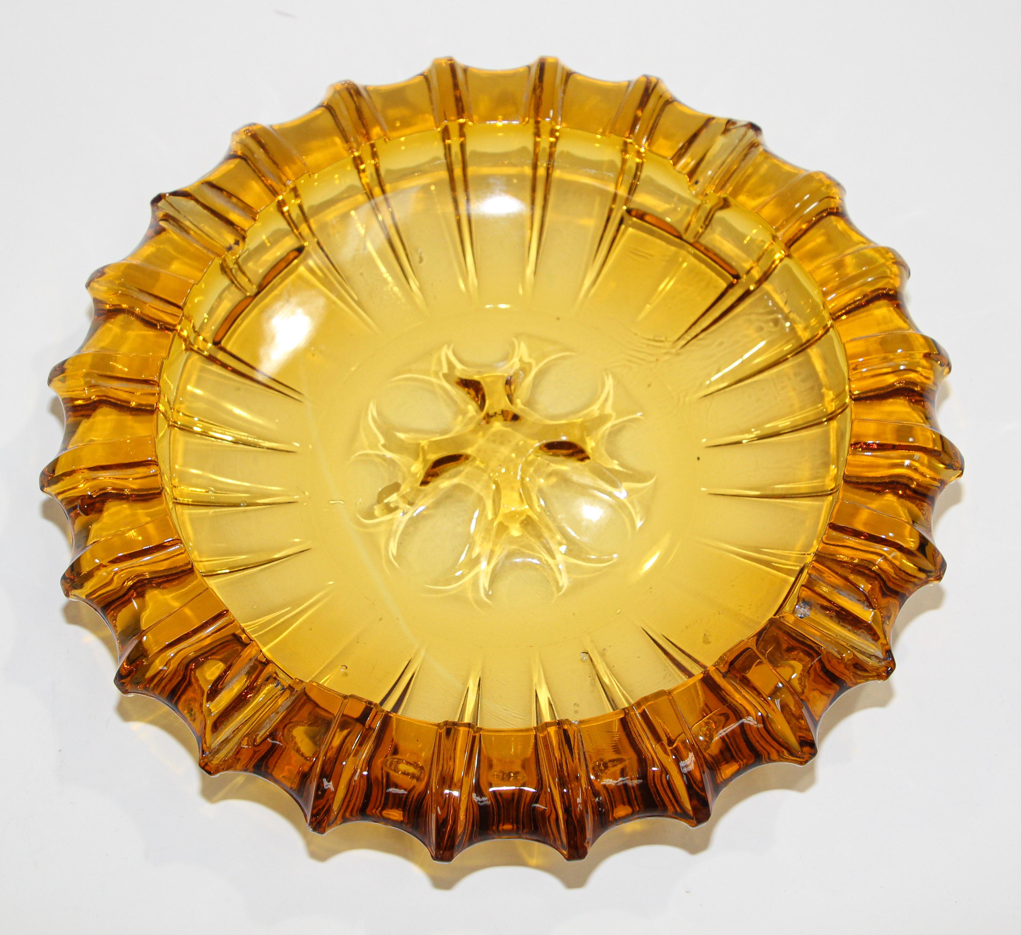 Moroccan amber glass ashtrays from the 1950s.
Vintage Hazel Atlas amber round sunflower form cigar ashtray.
Vintage hazel atlas Moroccan amber glass ashtray.
In excellent condition, great amber glass.
A great addition to any retro or Mid-Century