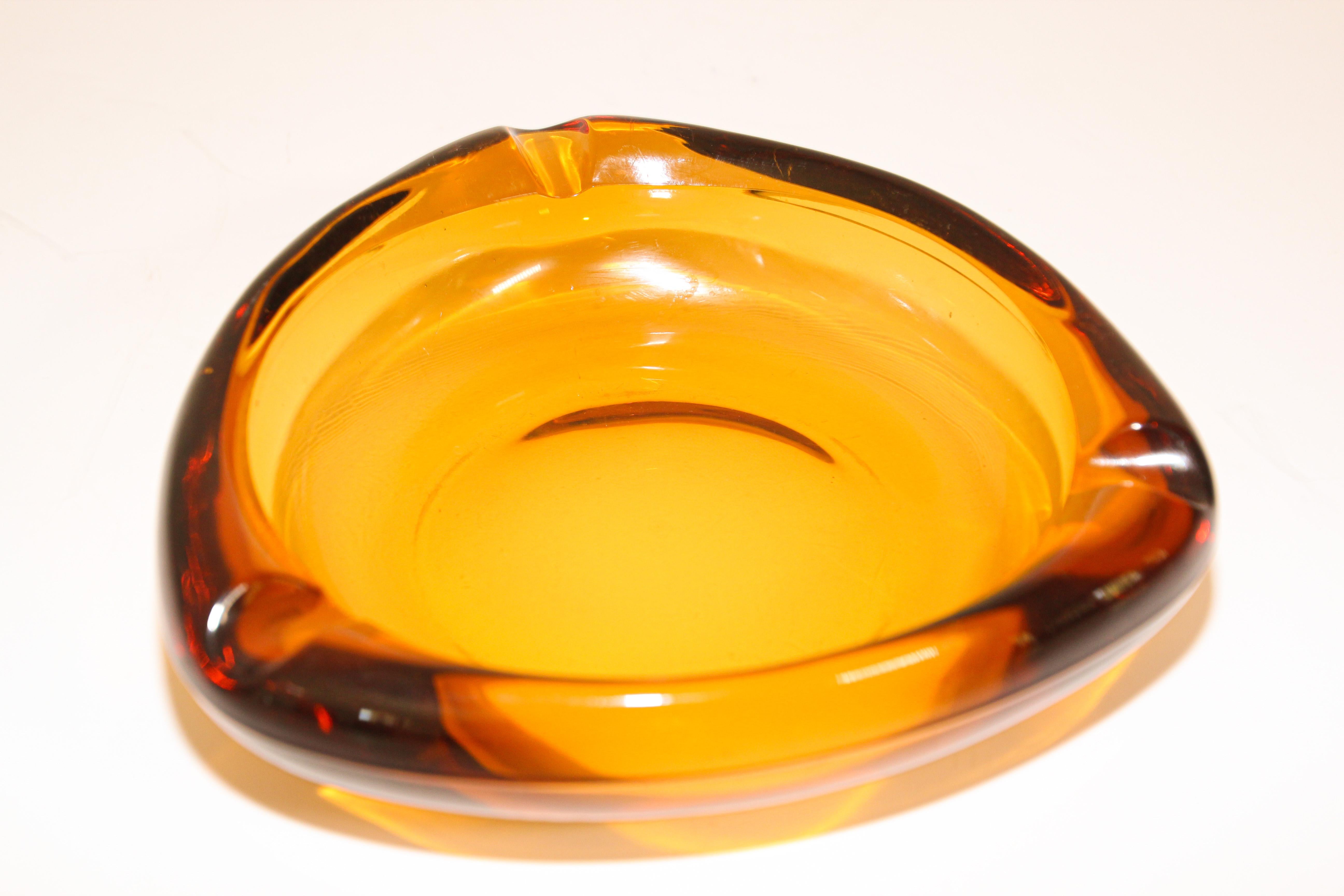 Moroccan amber glass ashtrays from the 1950s.
Vintage hazel atlas Moroccan amber glass ashtray in a triangle shape.
In excellent condition, great amber glass.
A great addition to any retro or Mid-Century Modern decor.
Measures: 8