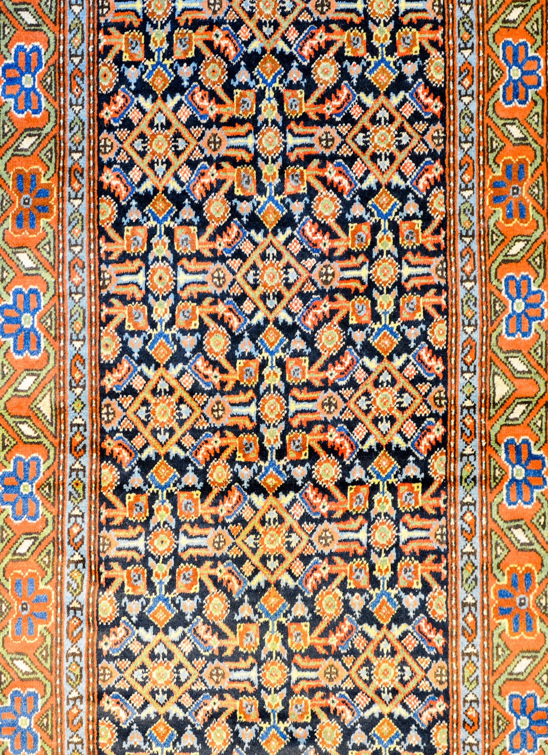 A wonderful antique East Turkistan Herati rug with an all-over multicolored trellis pattern with leaves and stylized flowers on a black background. The border is wonderful with a wide central floral stripe flanked by petite floral patterned stripes.