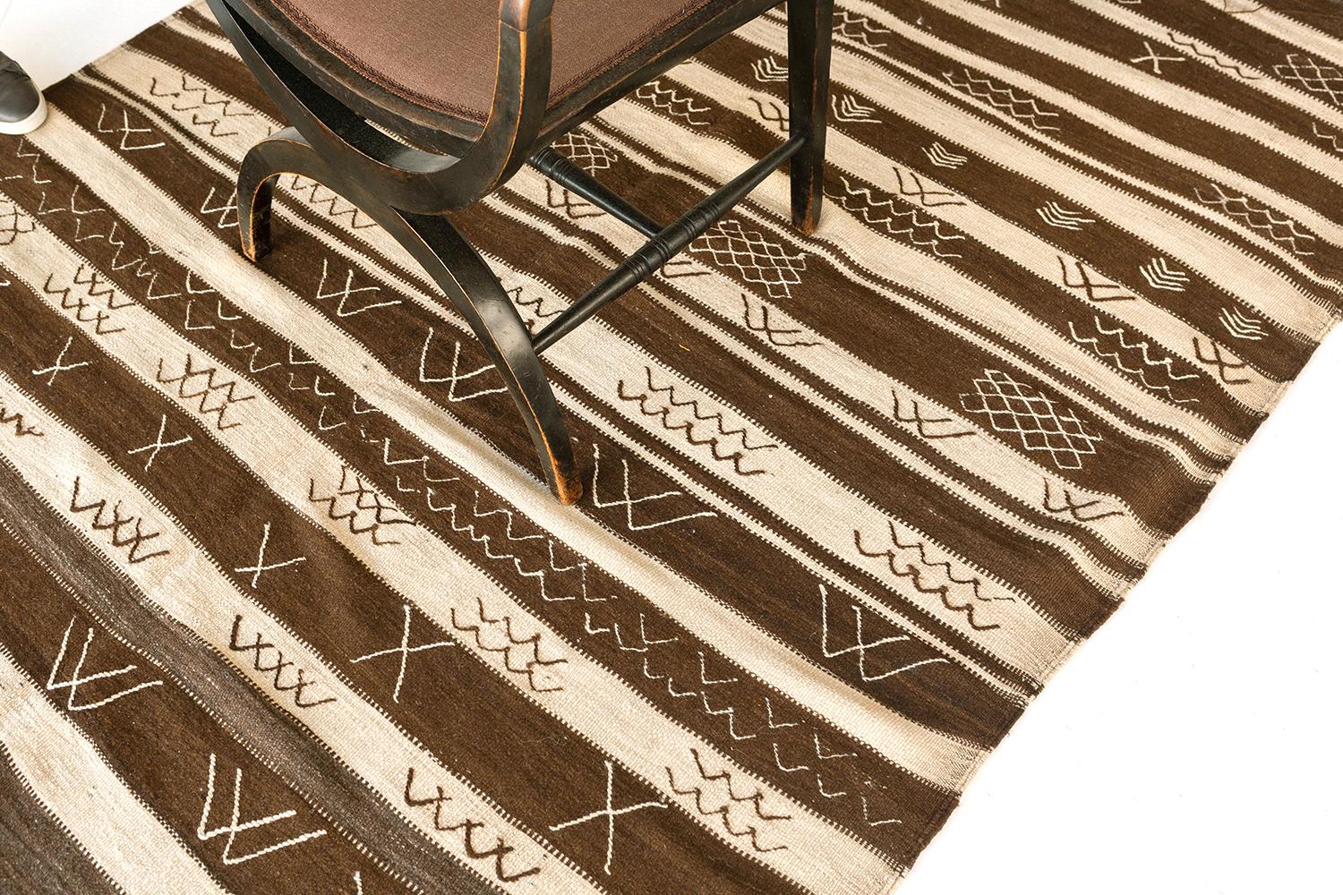 This stunning hand-spun flat woven wool of High Atlas Moroccan rug vividly features the waves, lozenges, and chevrons in neutral palettes. Unique horizontal patterns are perfectly matched with the Berber symbols. A great choice for your boho chic