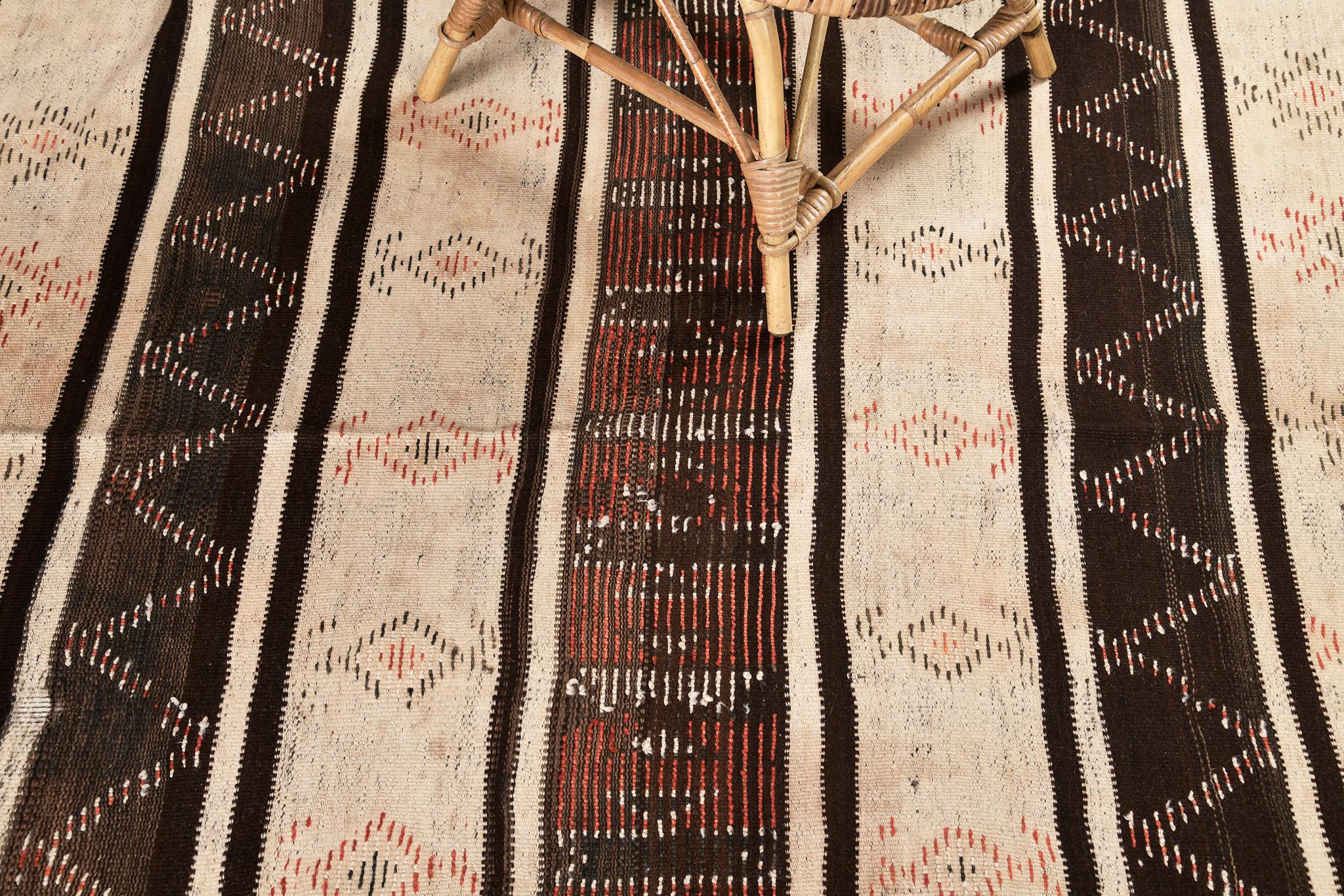 Banded flatweave in alternating natural brown and ivory. The piece is embellished with a knotted pile pattern in coral, pink, ivory, and apricot, tempered by irregularities of age.  A unique vintage tribal rug from the Atlas Mountains of Morocco.
