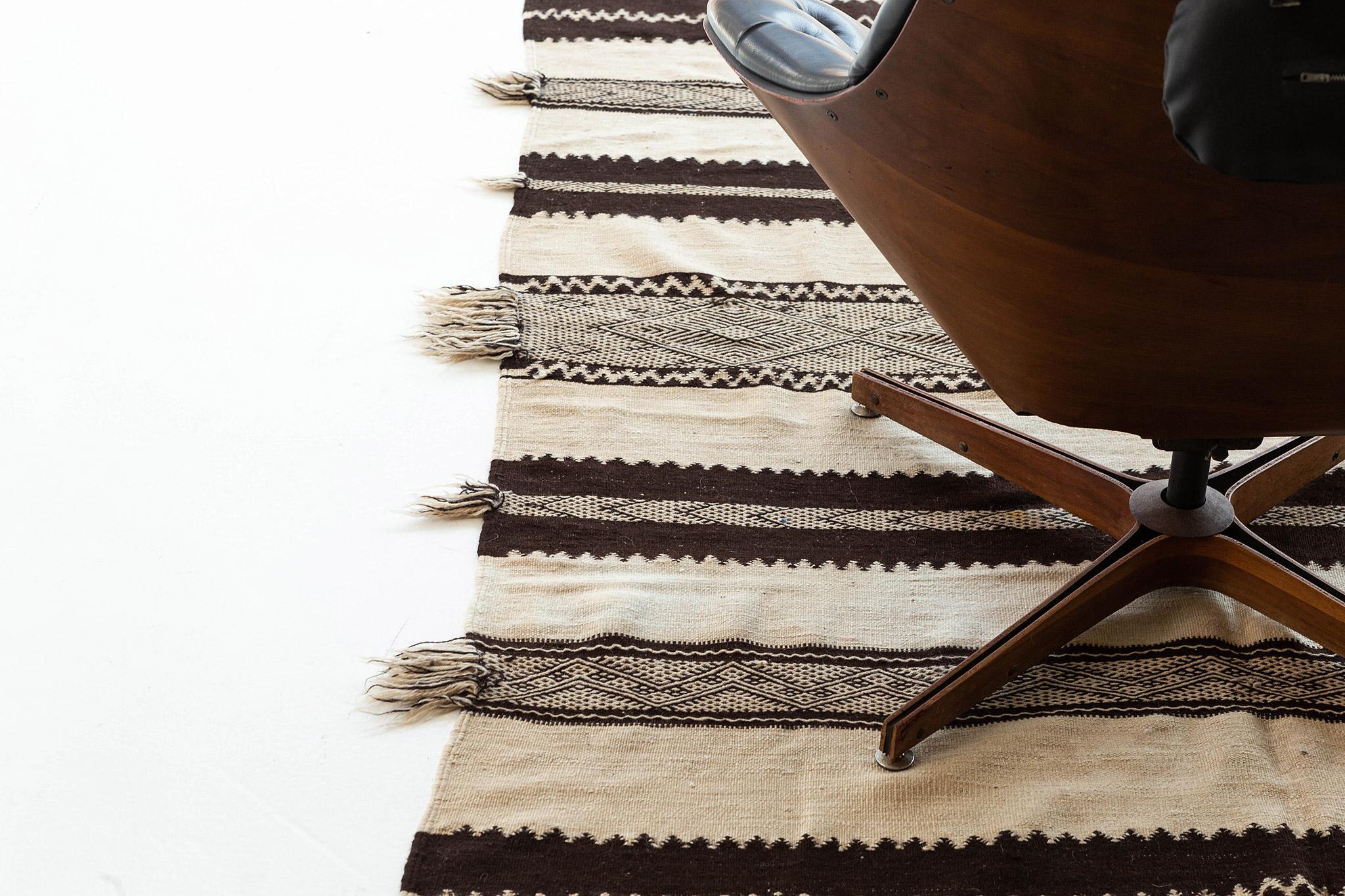 A phenomenal masterpiece that will make your bedroom, extraordinary. This Vintage Berber rug from Azilal Tribe features light palettes to a gray-scaled field. Flaunt your style with this remarkable and unique carpet to have a traditional and modern