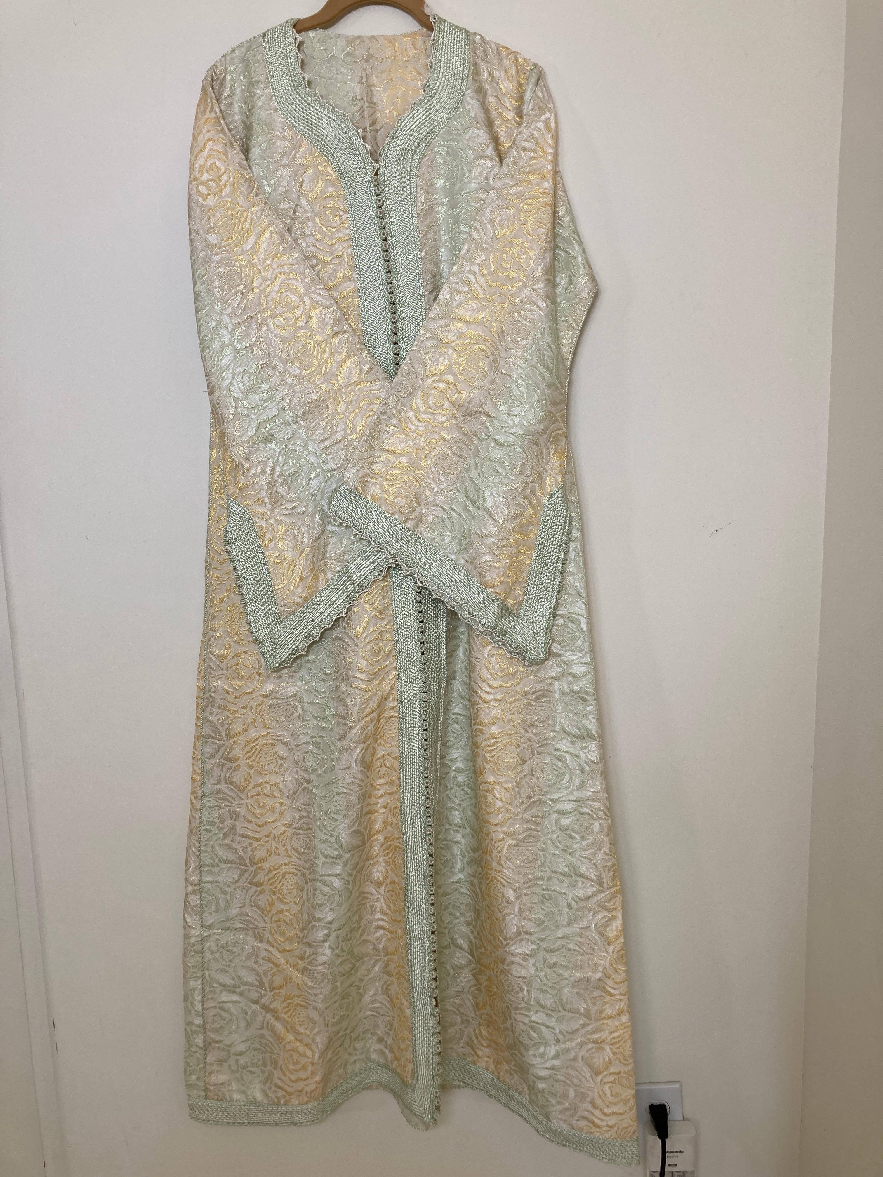 Amazing vintage Moroccan Caftan, gold damask with gold and sage rim threads, Circa 1970's
One of a kind evening antique Moorish gown.
This authentic caftan has been hand-sewn from damask fabric intricately embroidered with silk threads rim.
The