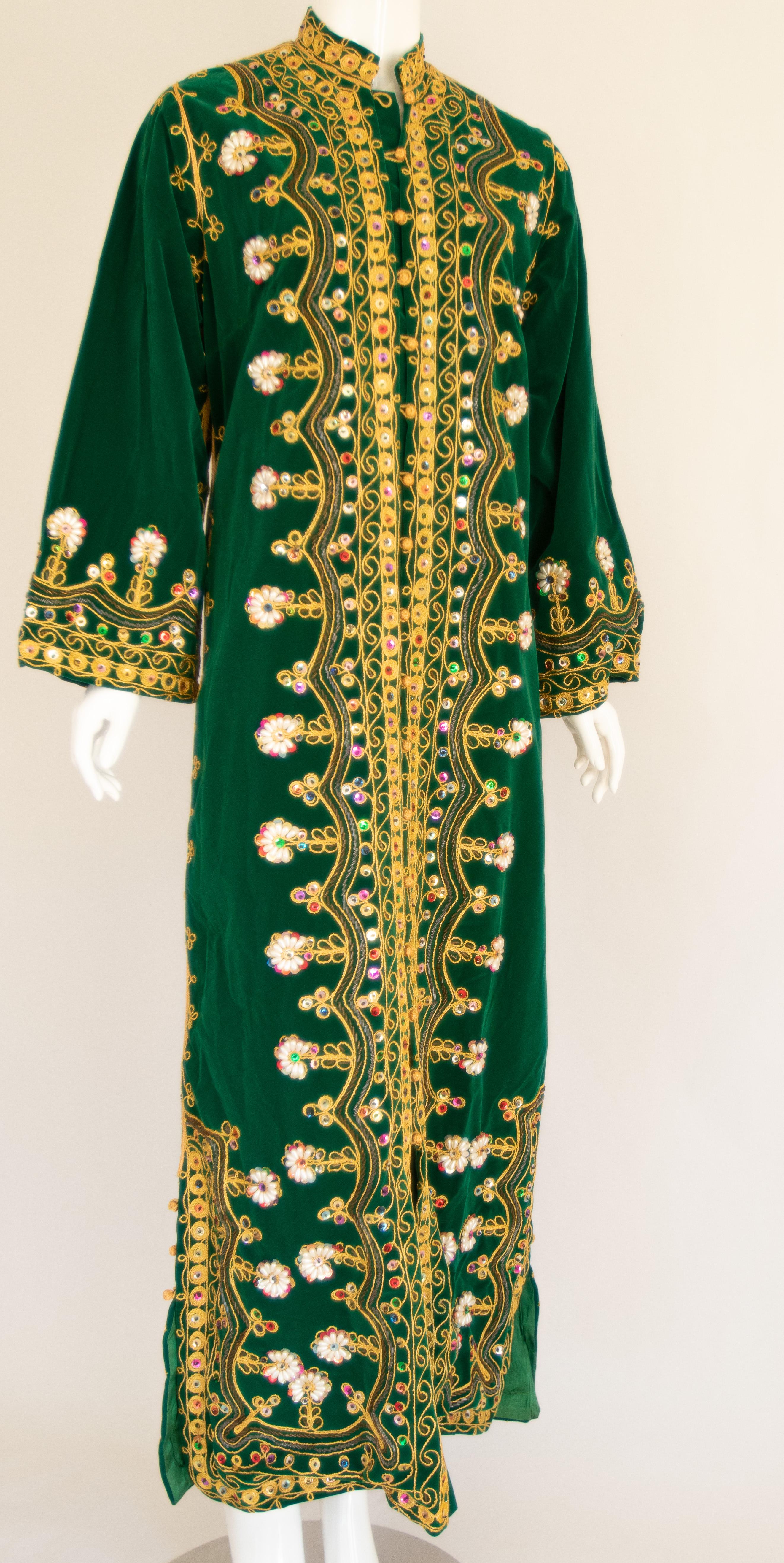 Amazing vintage Moroccan Caftan, green silk velvet with embroidered gold threads trim, Circa 1960's
The dark green velvet kaftan has been hand-sewn and intricately embroidered with gold threads rim and was entirely embellished by hand adding beads
