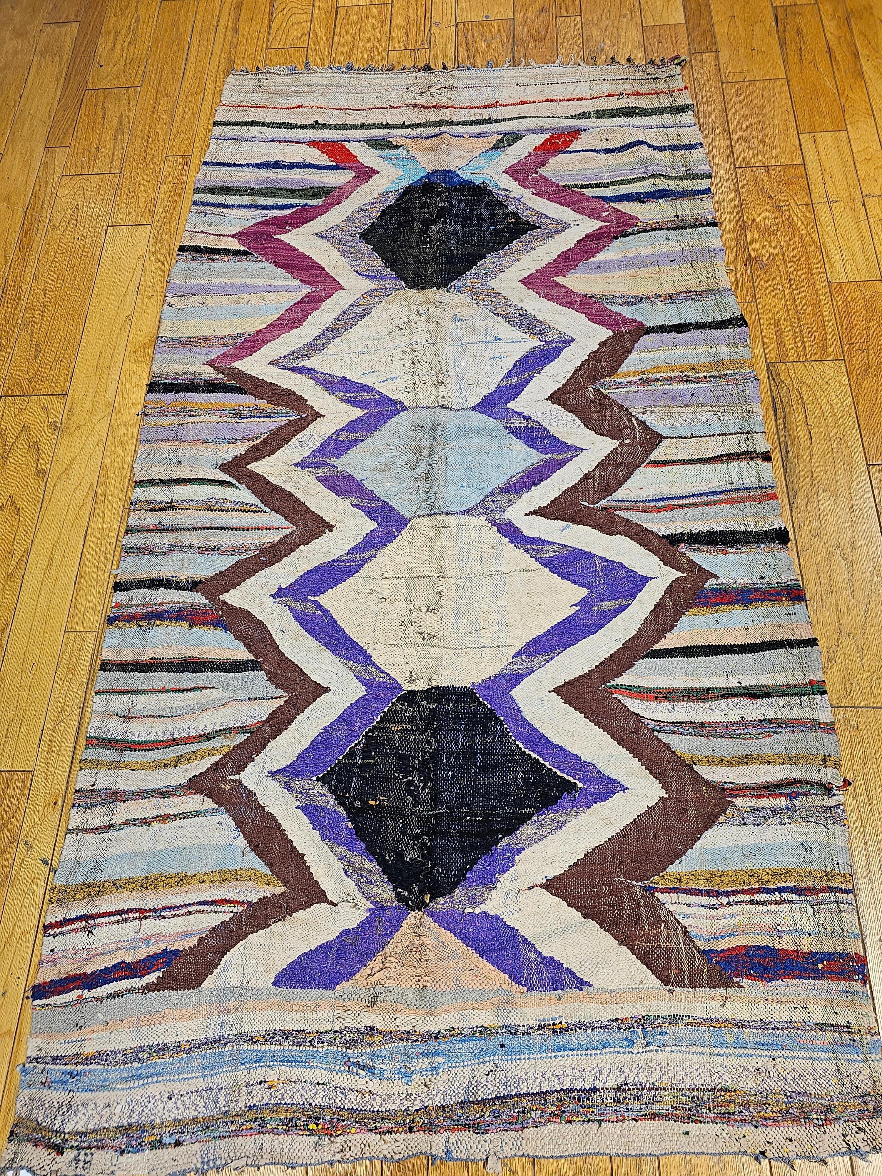 A vintage handmade  Moroccan flatwoven kilim with a wonderful large format geometric design pattern in beautiful colors of lavender, pale yellow, red, and black.  The kilim is the foundation piece for a Boucherouite rug.  The word “Boucherouite ''
