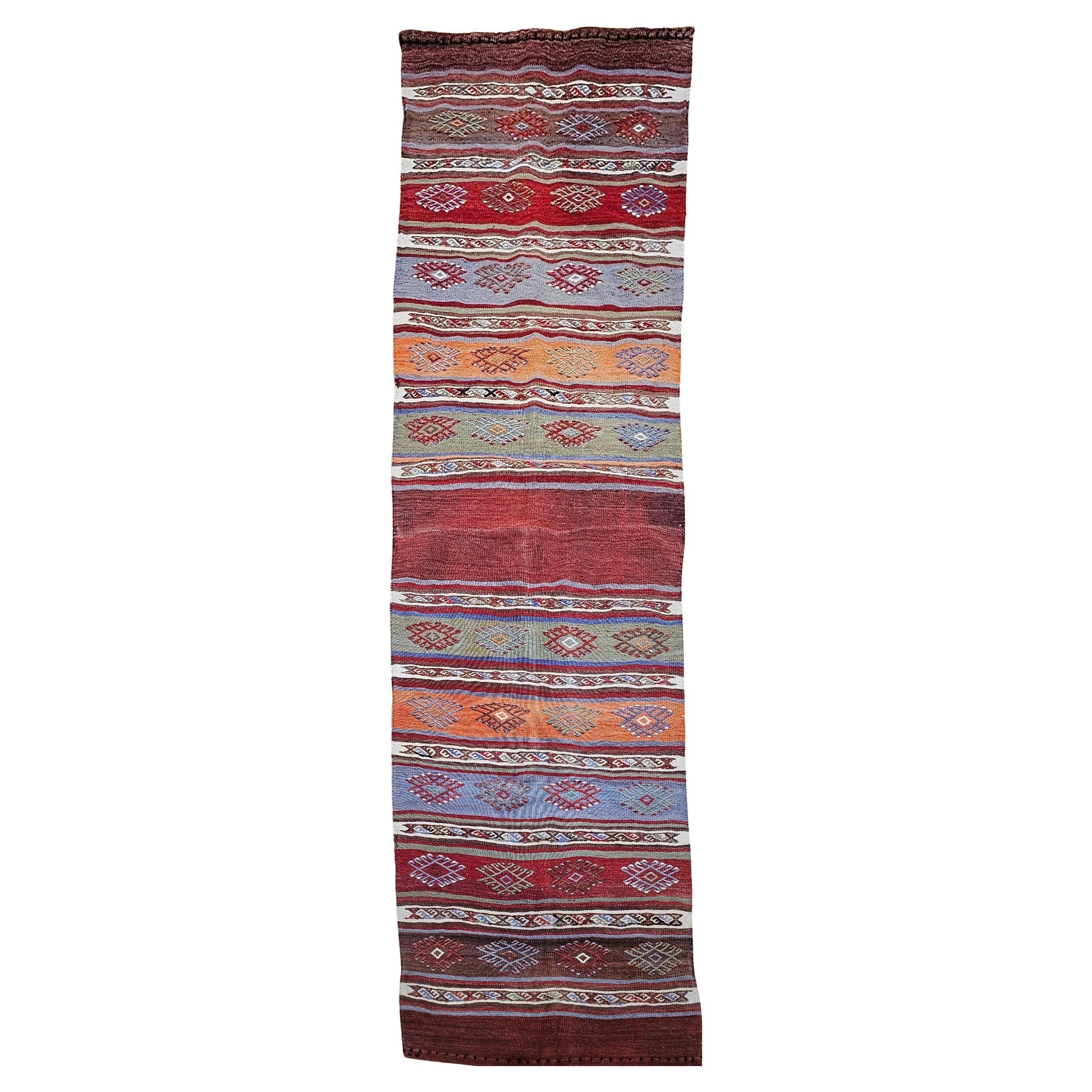 Vintage Moroccan Kilim Runner in Geometric Banded Pattern in Red, Purple, Green For Sale