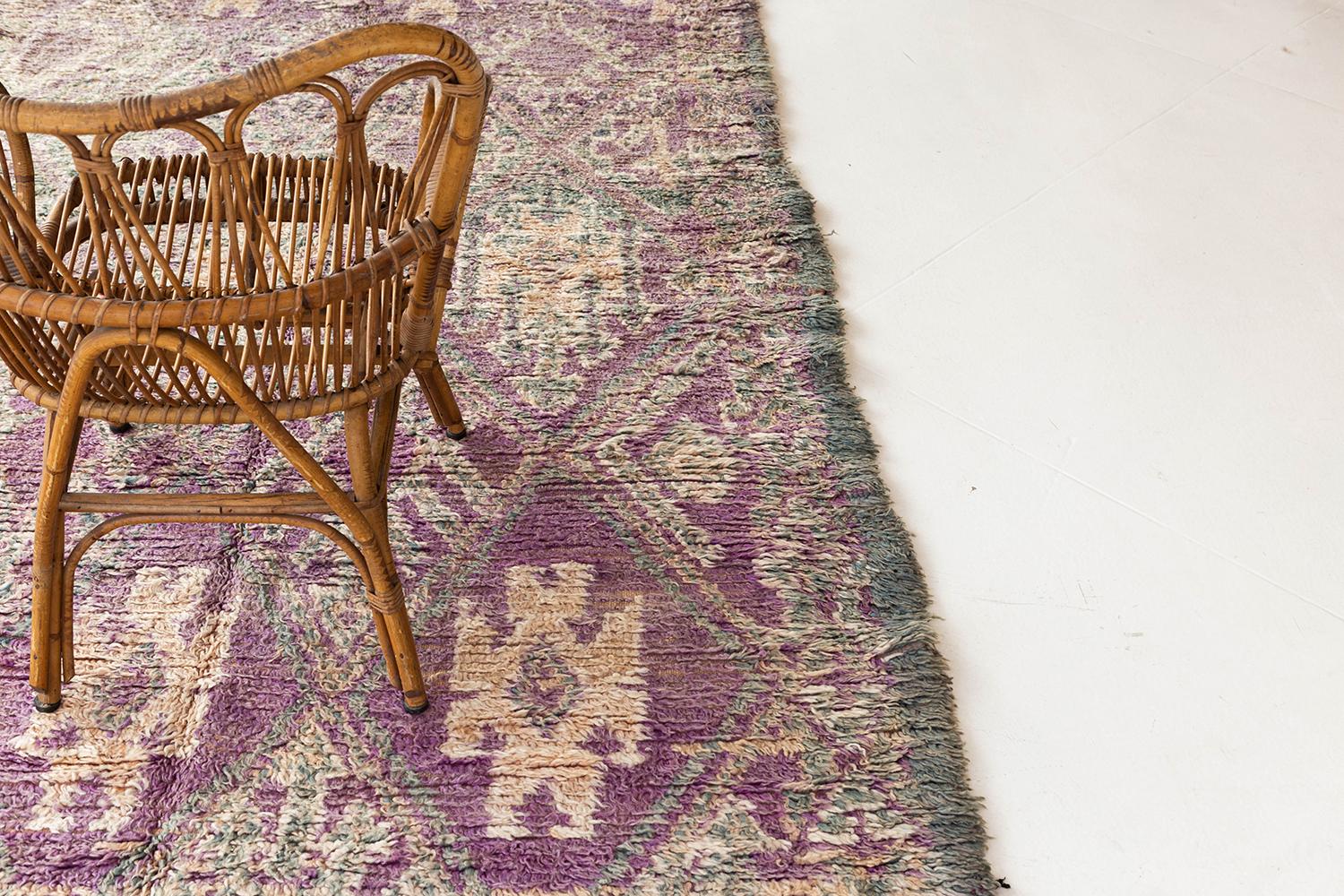A charming purple, ivory, and blue Berber rug from the Middle Atlas Tribe of Morocco. This unique hand woven pile, weaved by the MGuild tribe, will add character to any room with its symbolic imagery and geometric patterning. 


Rug number