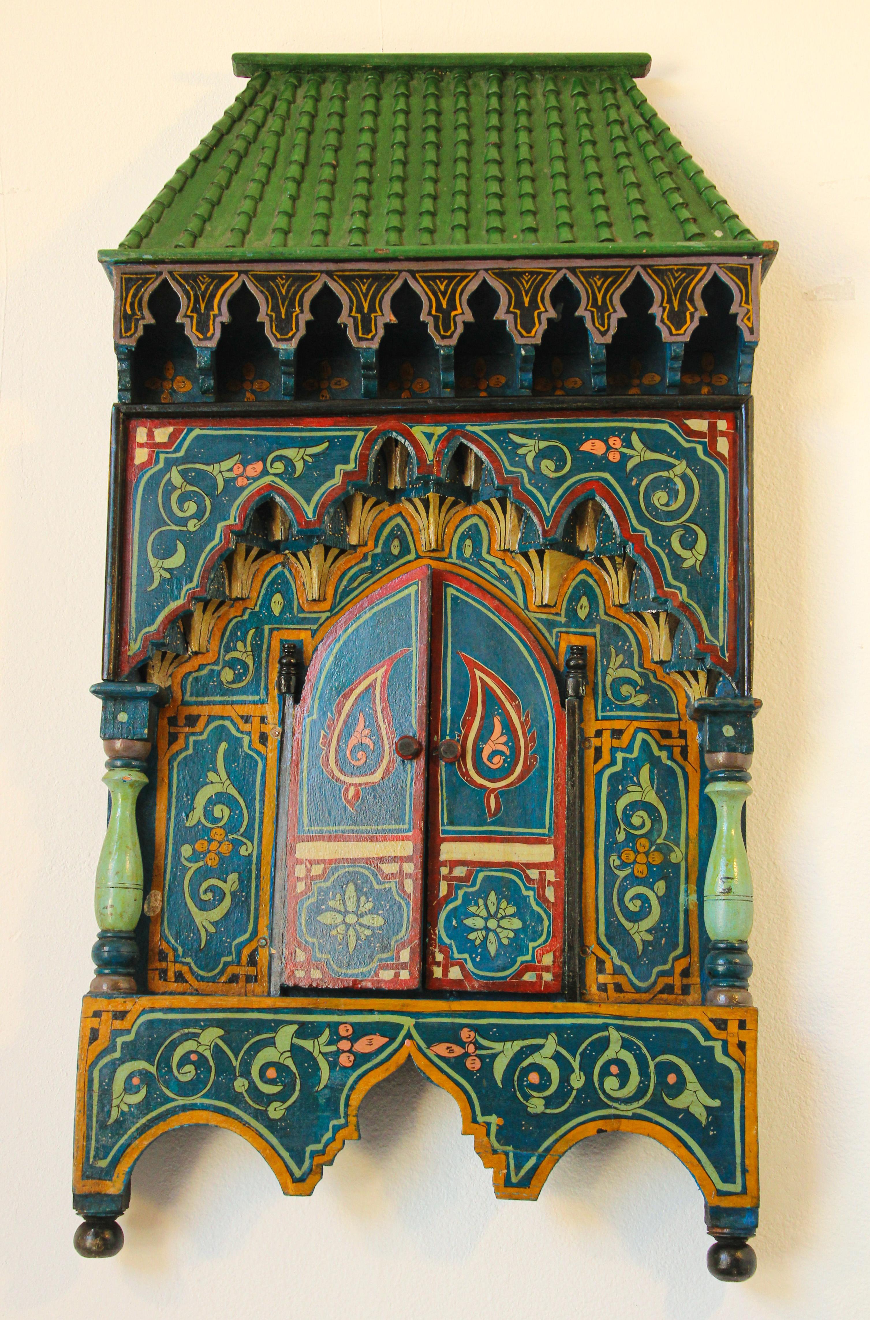 Vintage Moroccan mirror, hand painted, wooden window shaped mirror.
Beautiful hand crafted mirror in a traditional hand painted Moorish detailed design with elaborate arabesque, ornamental, intertwined flowing lines, great colors in dark green,