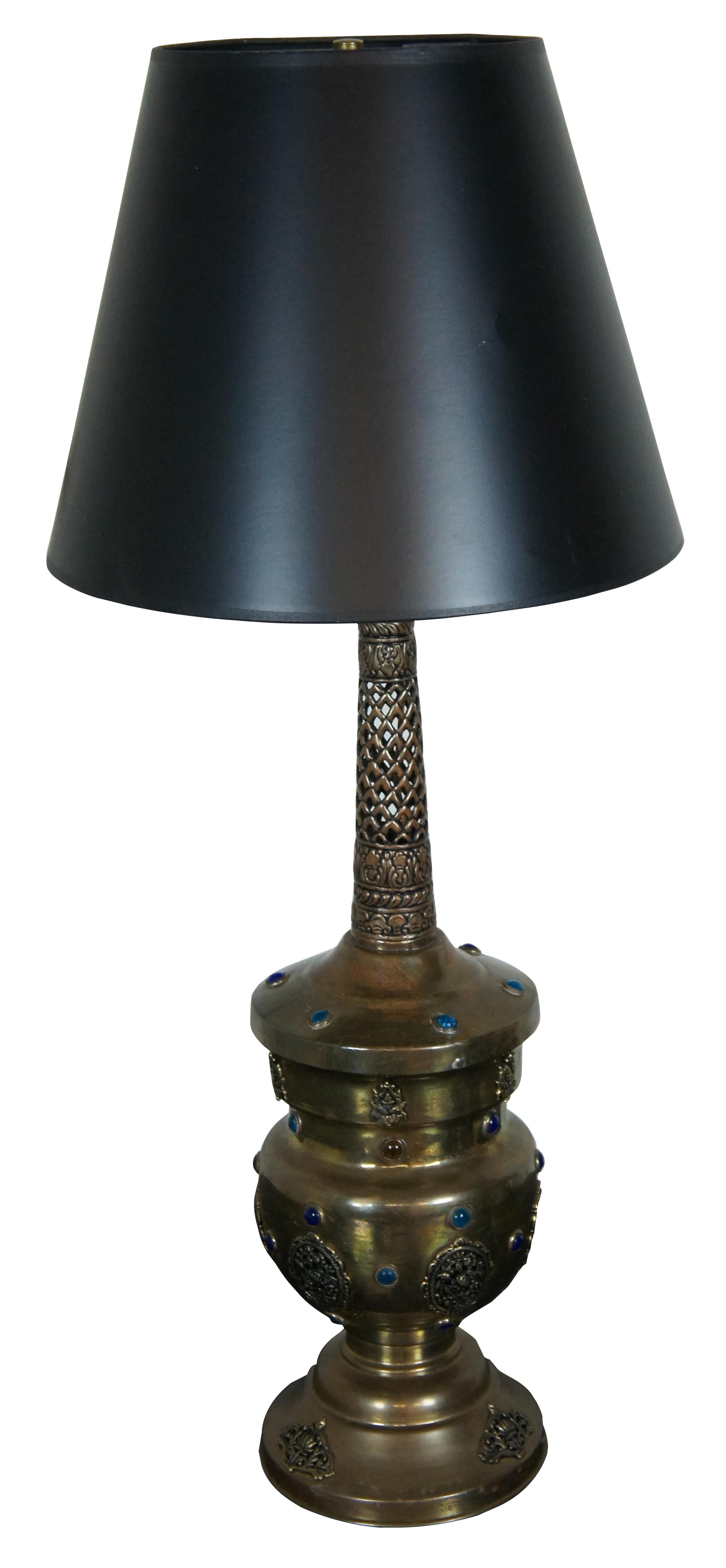 Vintage Moroccan / Moorish pierced brass table lamp decorated with floral motifs and multi-colored gemstones.

Measures: 7” x 26” / Shade - 14” x 11” / Total Height – 33” (Diameter x Height).
