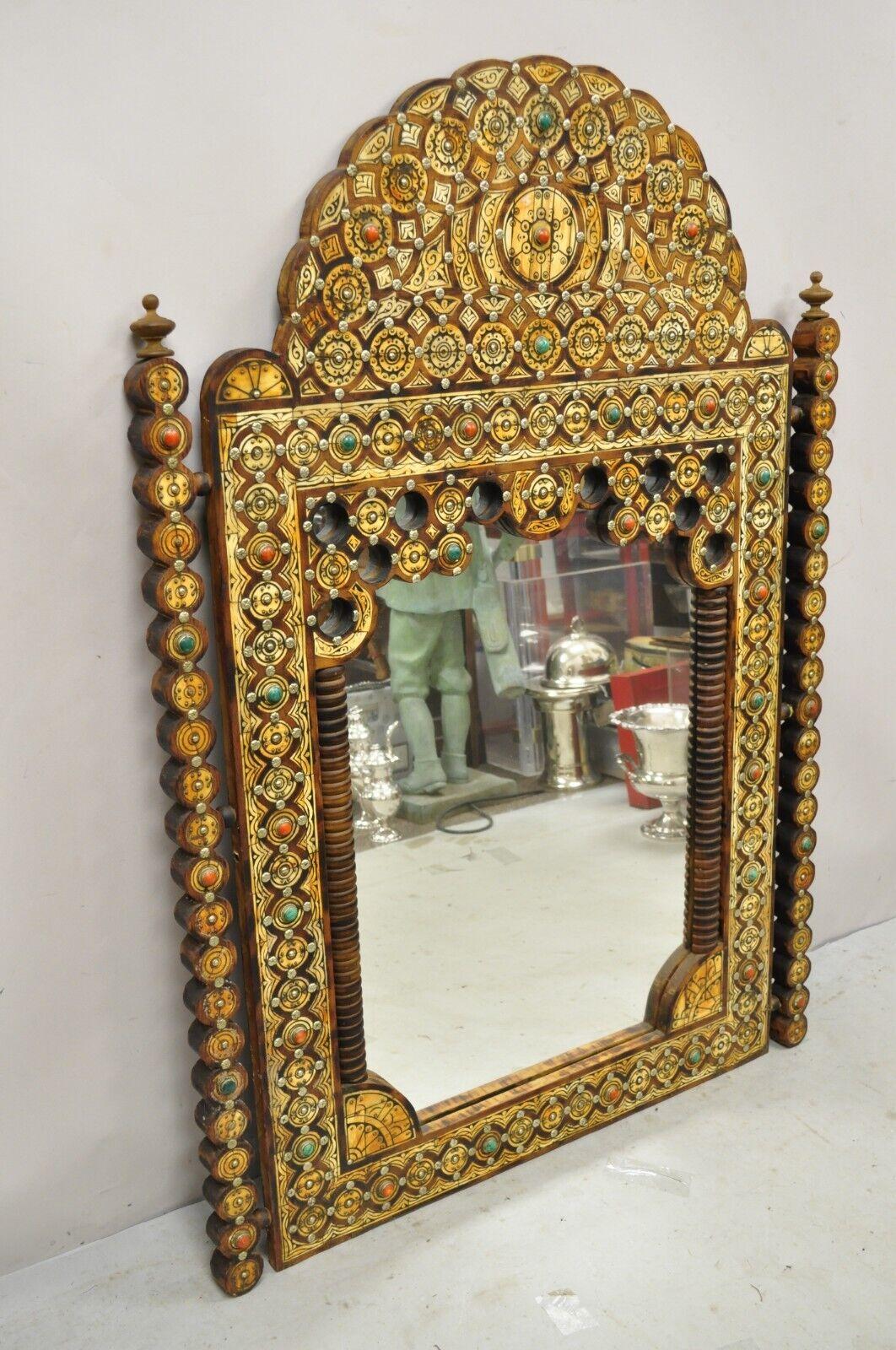 Vintage Moroccan Moorish Style carved wood mirror with Jewel Accents. Item features jewel and metal accents, nicely carved frame and finials, nice impressive size, very nice vintage item, great style and form. circa Mid to Late 20th Century.
