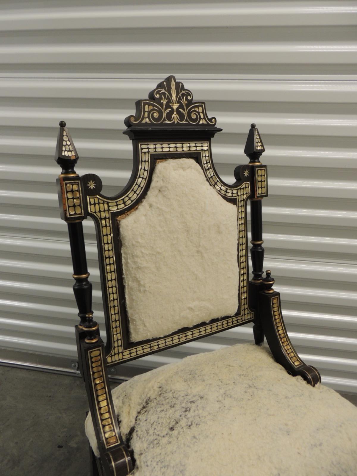 Vintage Moroccan mother-of-pearl inlaid frame and ebonized wood.
One-of-the-kind slipper chair, with original wool and horsehair stuff on back and seat.
Turned wood legs with gold leaf painted details.
Very sturdy side chair needs a new