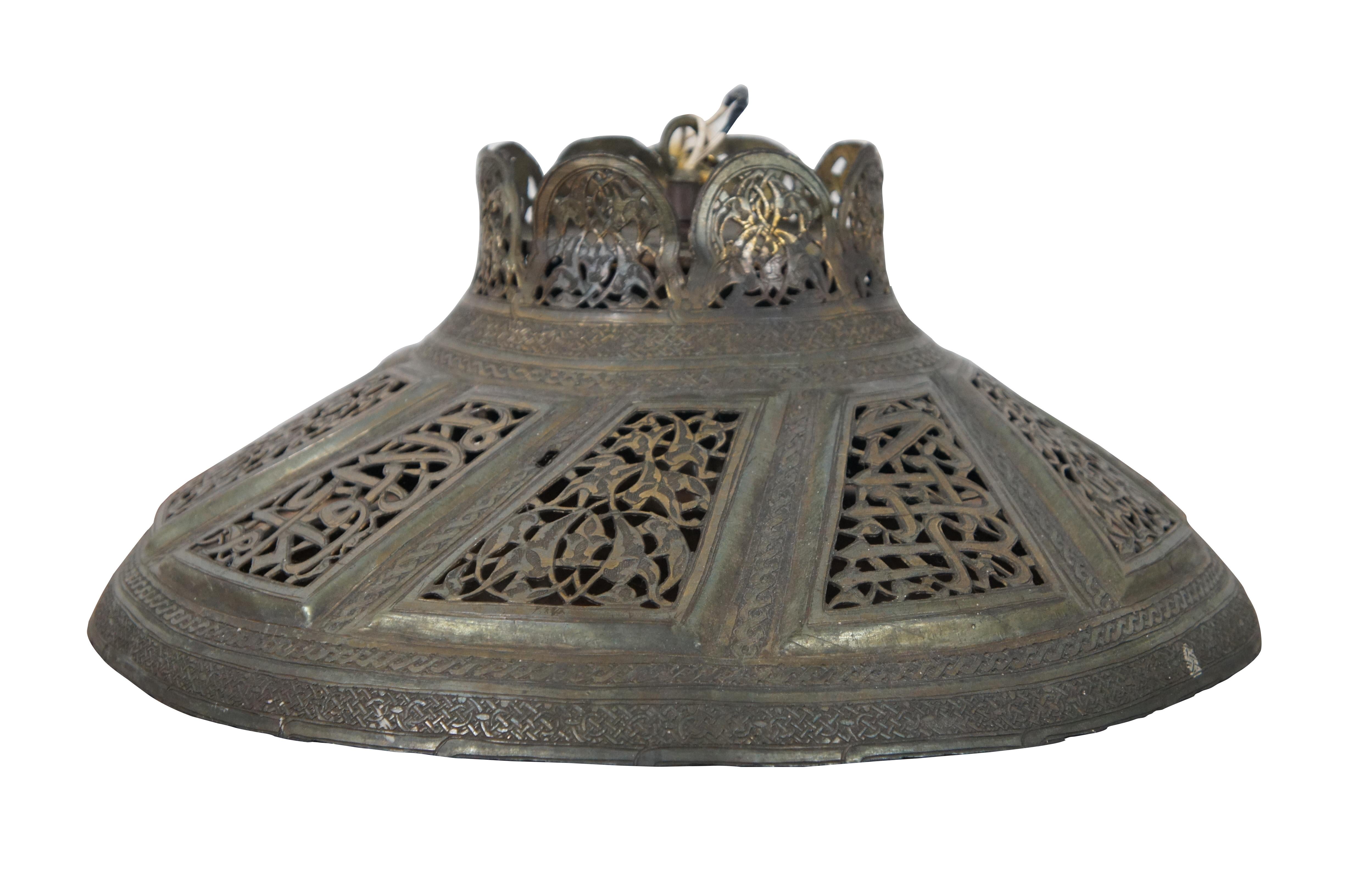 Vintage pierced brass chandelier / pendant / ceiling / swag light or shade, featuring Turkish or Moroccan styling with pierced panels and scalloped top with a floral / foliate design, edged in Celtic style knot work.

Measures: 16.5” x 7” / chain