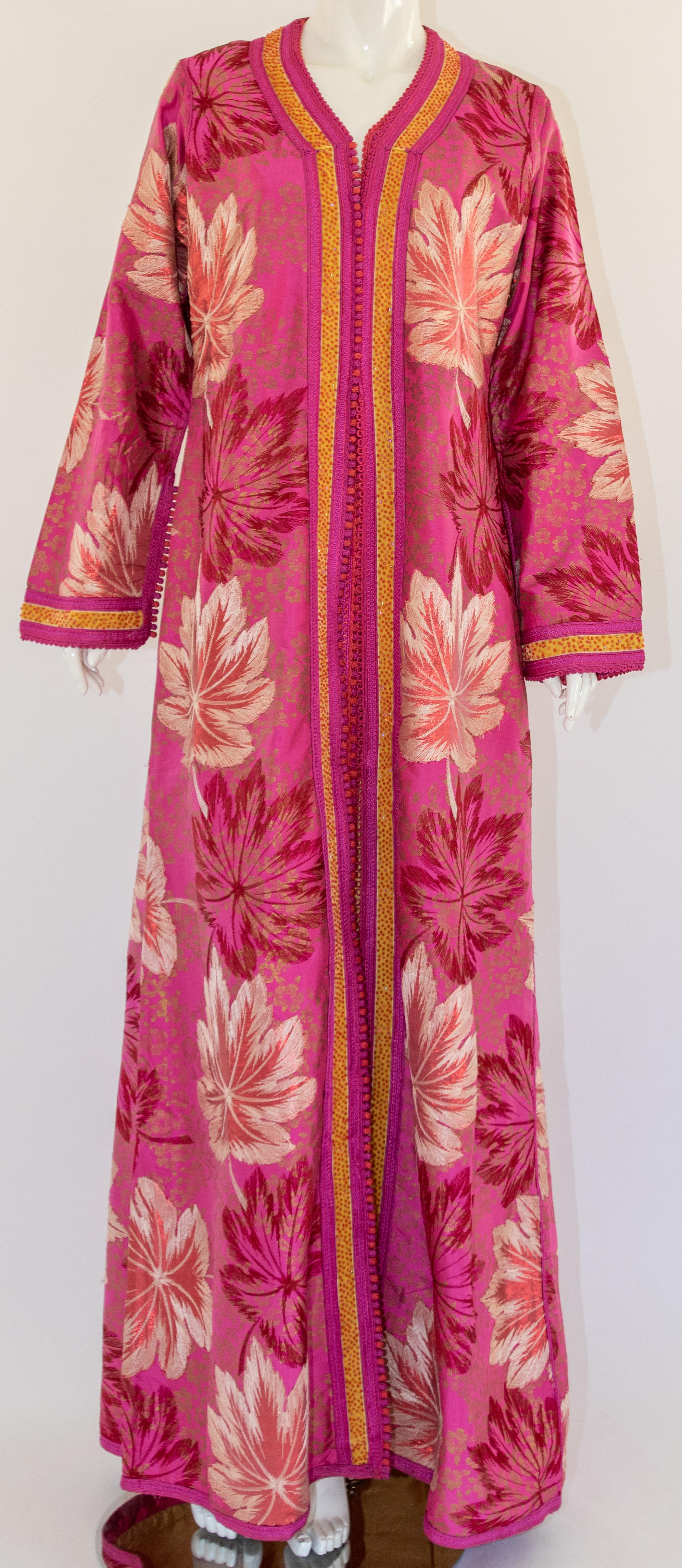 Elegant vintage brocade Moroccan kaftan, embroidered with pink and gold.
This chic Gypsy Bohemian maxi dress brocade kaftan is embroidered and embellished with handwoven thread pink and gold trim. 
It is a slip on, the button does not open, it has
