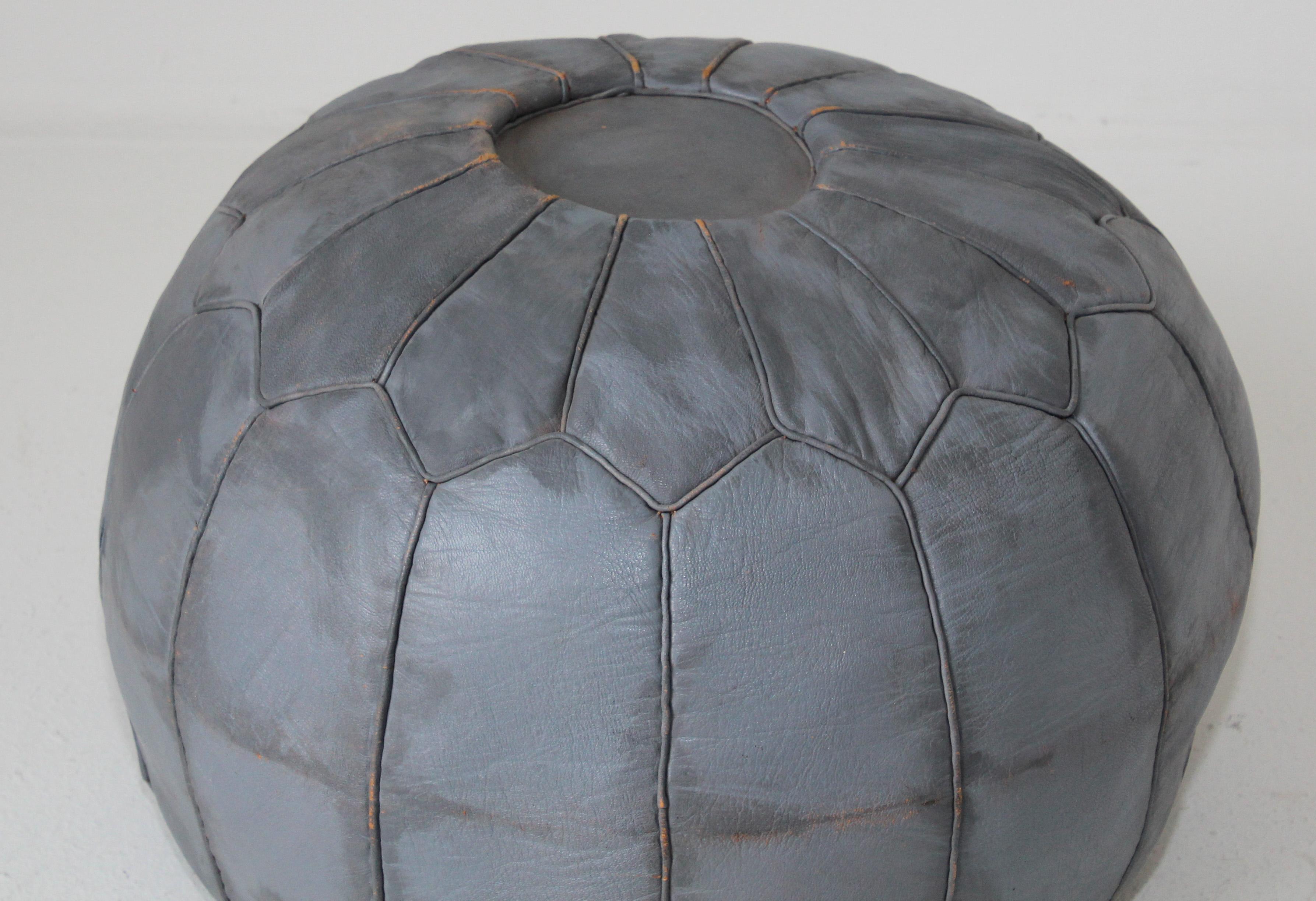 Vintage Moroccan grey leather round pouf hand tooled in Fez Morocco. 
Foot stool, ottoman handcrafted by Moroccan artisans. 
Size is 19 in diameter x 12.5 in height.
Vintage Bohemian style, circa 1960-70's.
Handmade with no zipper but with holes