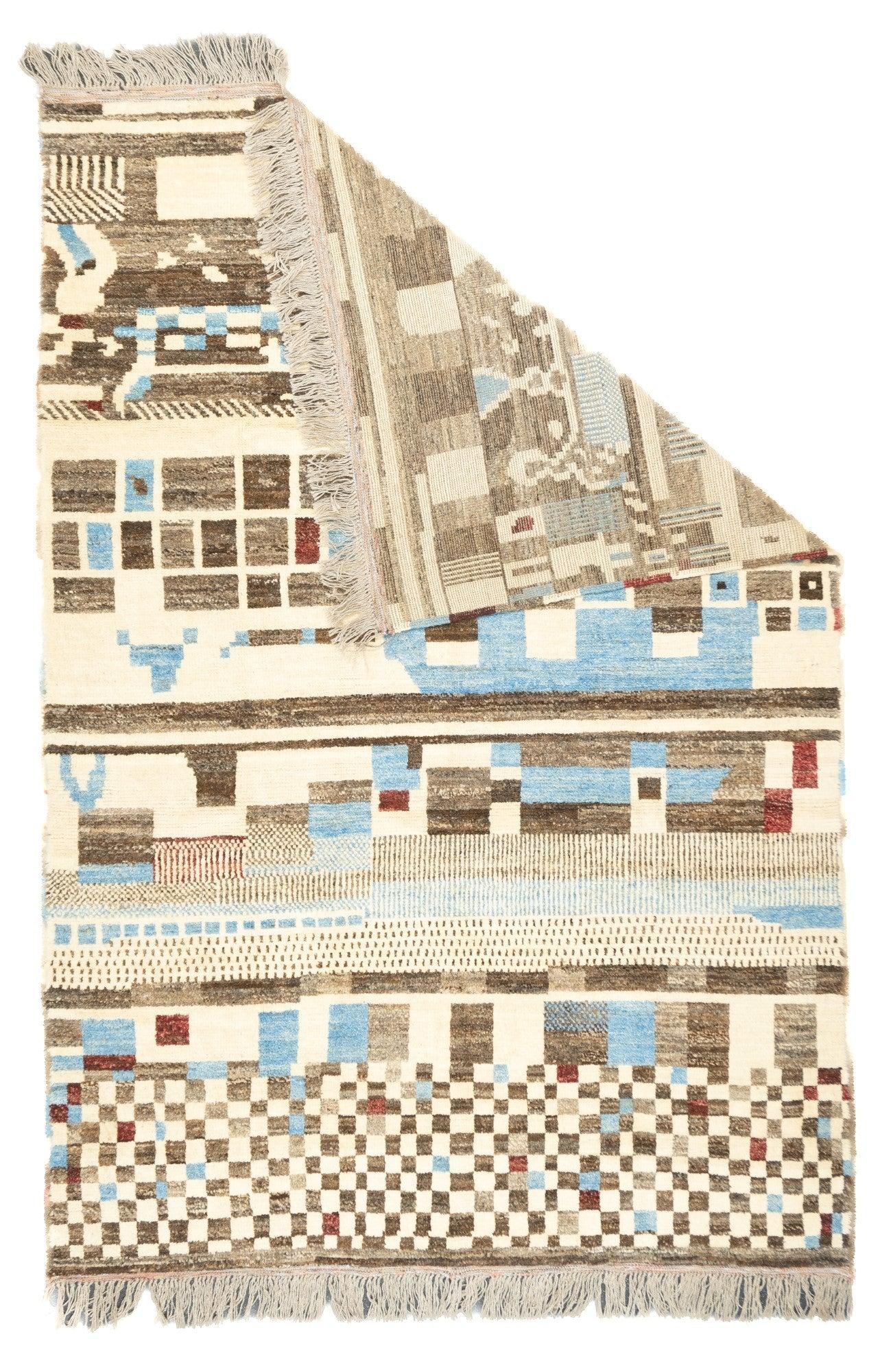 Vintage Moroccan Rug 6'10'' x 9'11''. This is a totally crazy rug with bands of large squares, a colorful chessboard, stripes, fences, and an indescribable panel, all in shades of ivory, pale blue and several abrashed browns. High pile, coarse