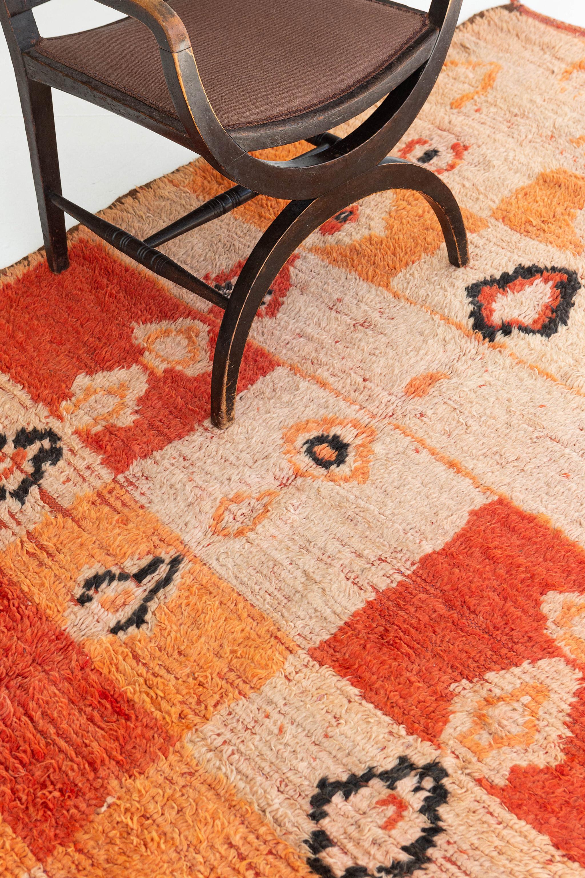 A grandiloquent Azilal Tribe Moroccan rug that consists of ambiguous Berber symbols. The rug makes your space more feminine because of the combinations of colors used. Series of diamonds in playful colors make the whole design is well-incorporated