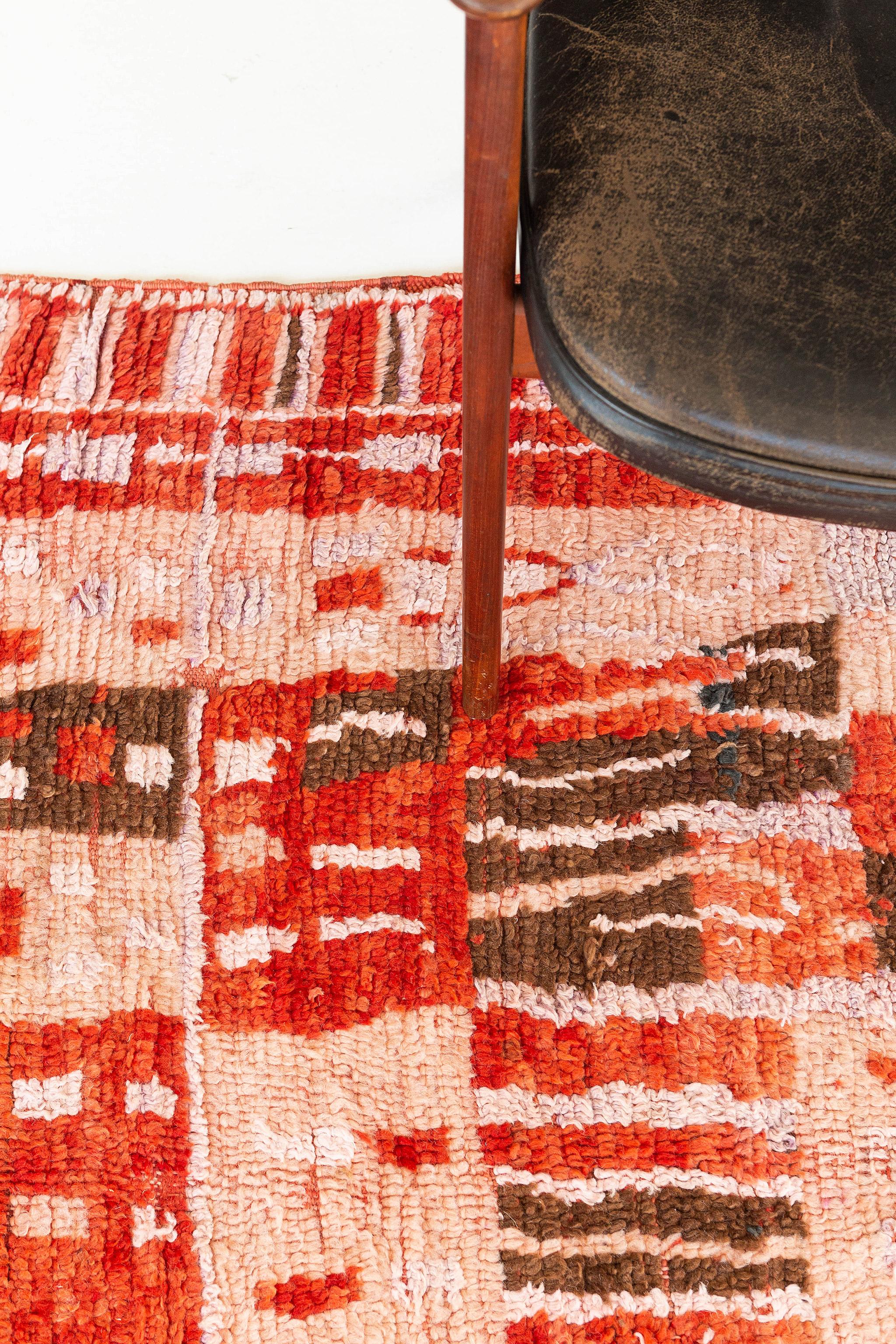 This artistic creation Berber Rug from Azilal Tribe has its beauty to modify your space into a traditional style. A centerpiece that fits your bedside decor. Vibrant colors such as red, coral orange, brown, and salmon pink are in a checkered pattern