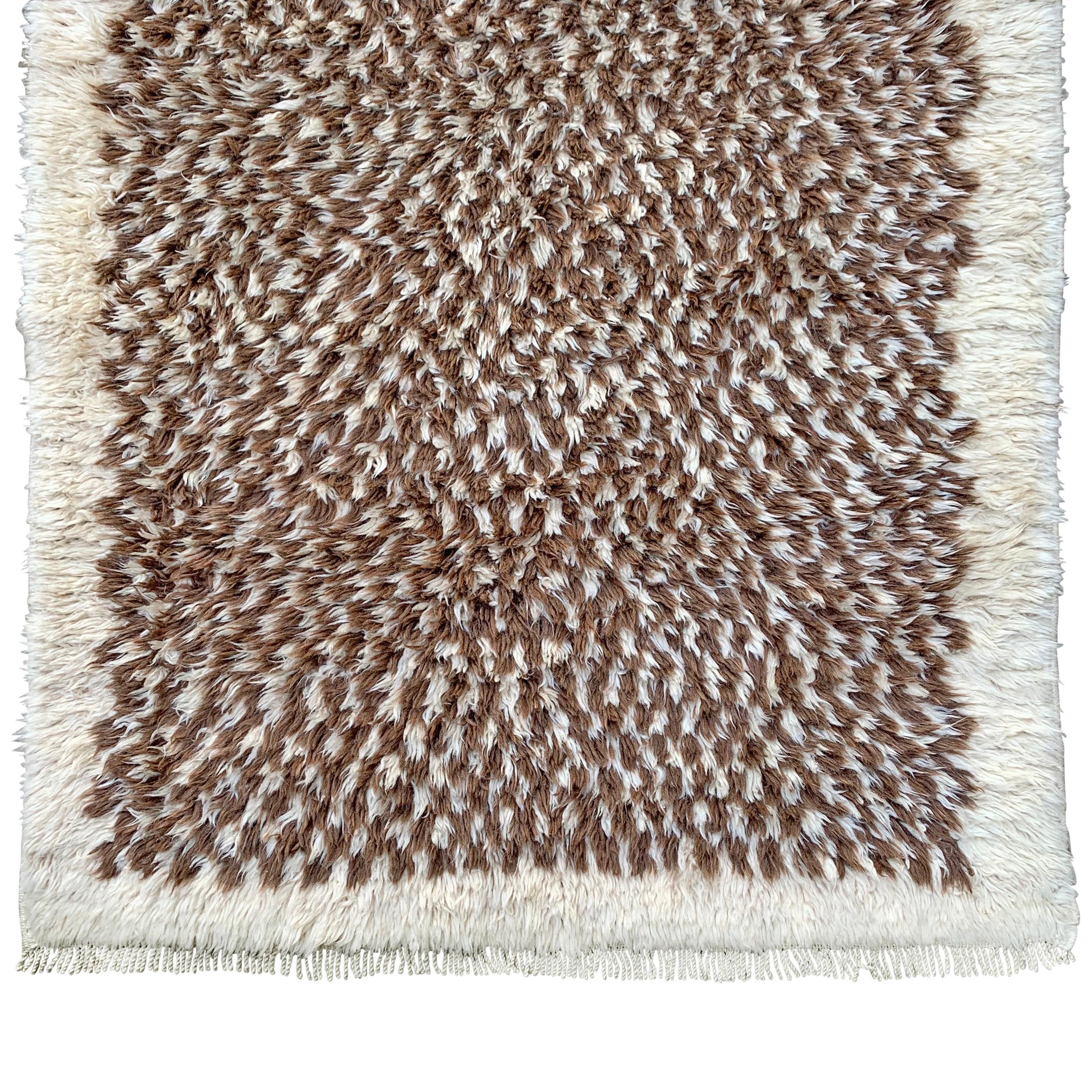 A smart vintage Moroccan rug with a stylized brown and white checkerboard pattern woven with a thick shag pile.