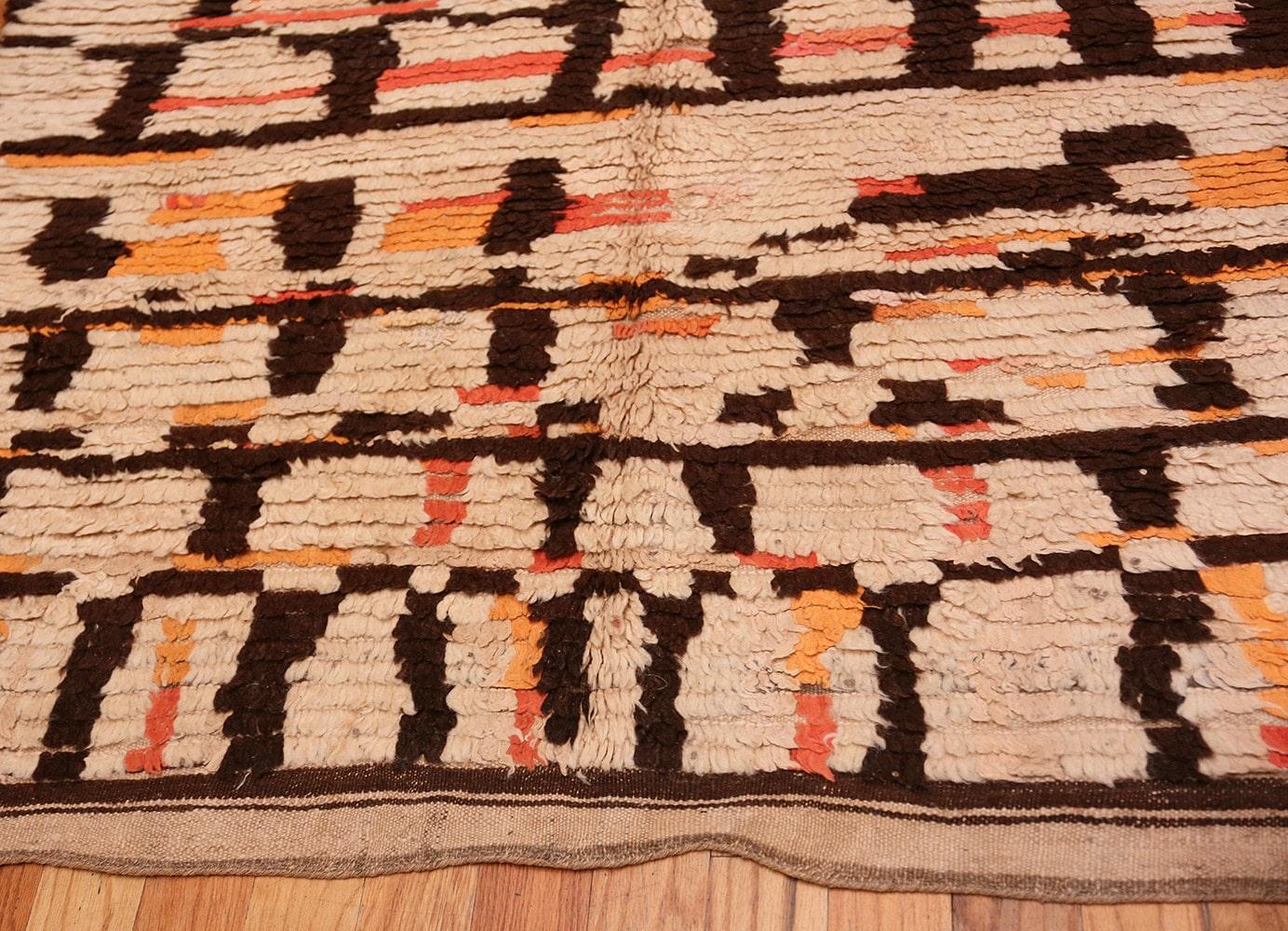 Vintage Moroccan rug, origin: Morocco, circa mid-20th century. Size: 4 ft 8 in x 9 ft 2 in (1.42 m x 2.79 m). 

Broken walnut brown bands and ivory cornerstones paired with pink and peachy orange checkers are arranged in a discontinuous composition