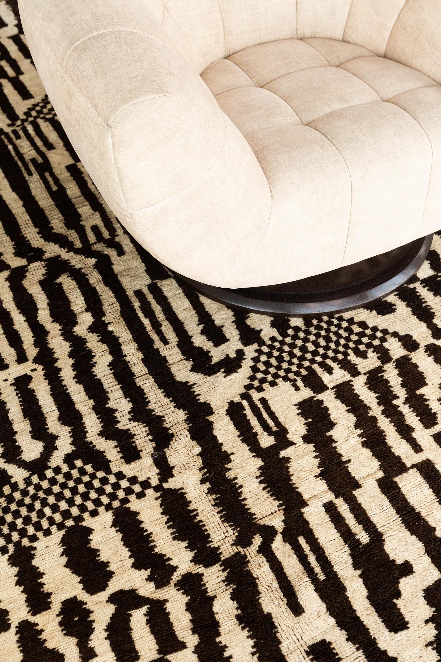 A bold and exciting vintage Moroccan from the High Atlas tribes of Morocco. This brown and cream colored wool pile weave contains tribal elements and symbolic imagery to make for the perfect contemporary. An antique art piece that will leave lasting