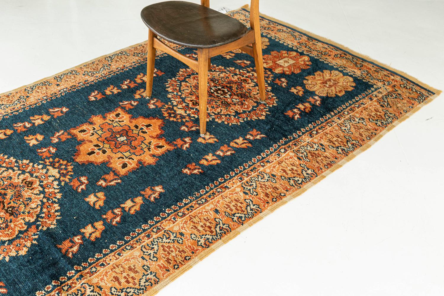 Boost your vitality by adding this sophisticated Moroccan rug from our Atlas Collections. It enhances your interior with this symmetrical motifs, lozenges, and defined medallions of red pear, valiant poppy, and russet orange, in a pacific blue