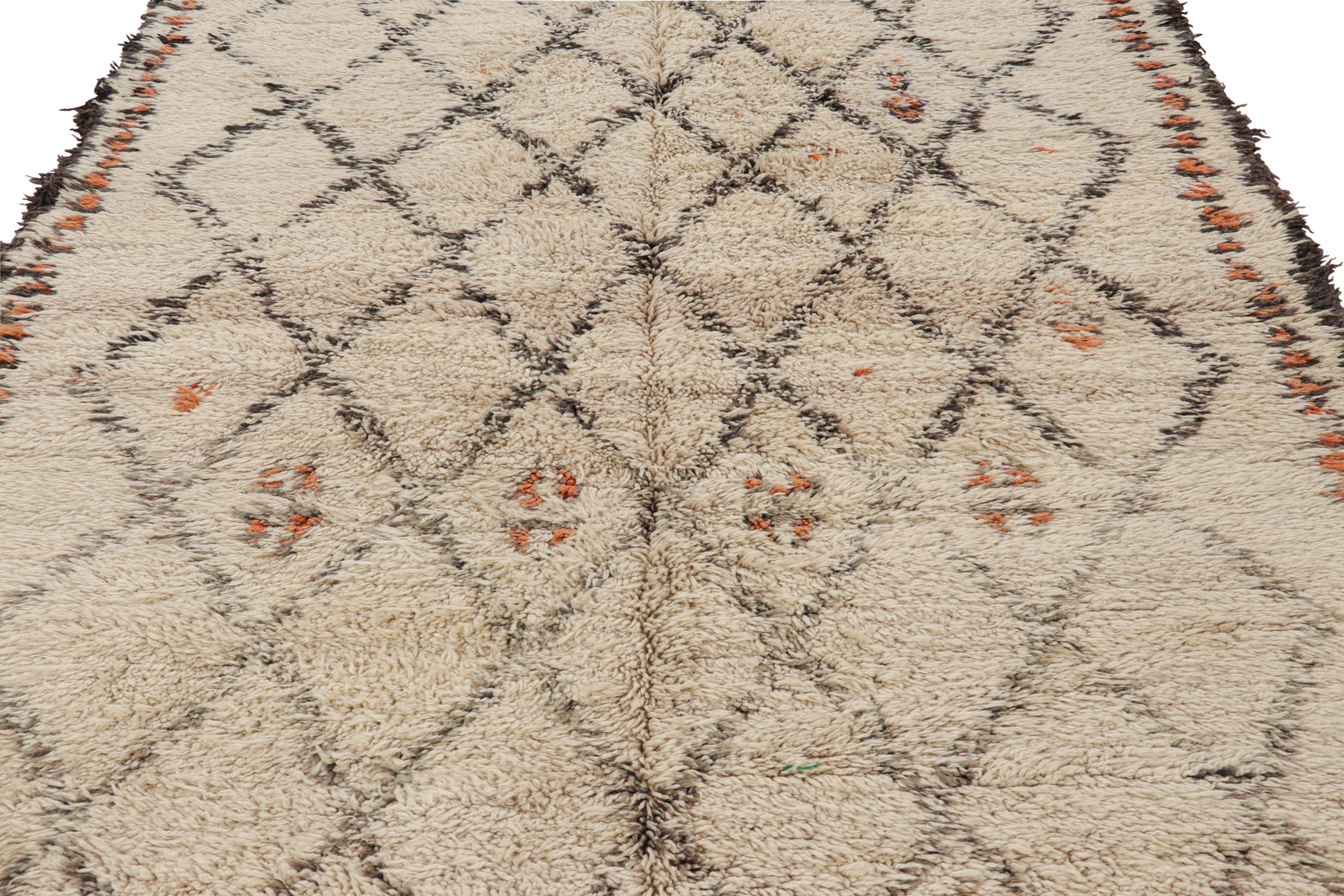 Hand-knotted in wool and originating from Morocco circa 1950-1960, this 6x11 vintage Moroccan rug is an extremely rare piece like so few of its provenance. 

On the Design: 

Admirers of the craft will note what an exceptional find this shabby chic