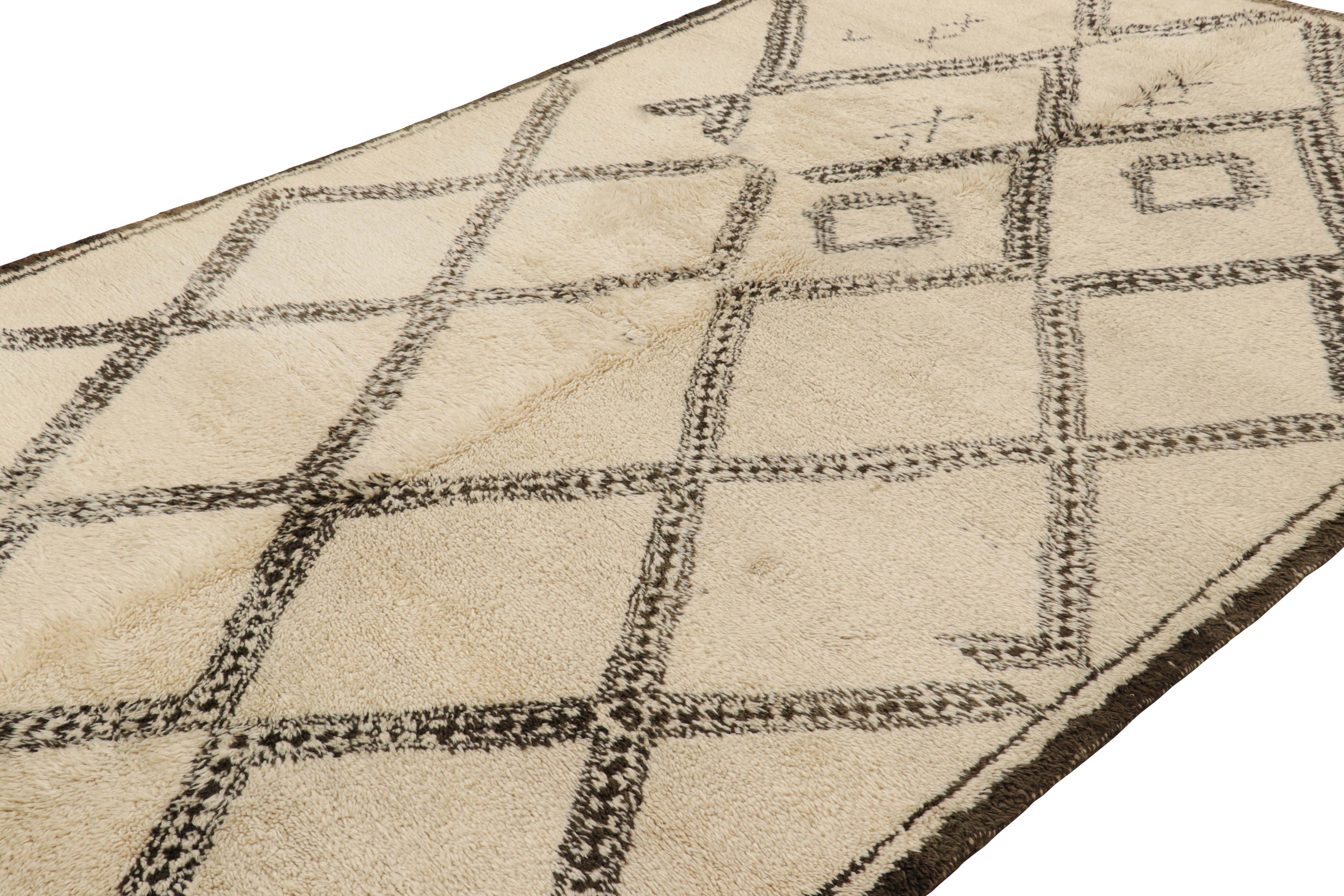 Hand-knotted in wool and originating from Morocco circa 1950-1960, this 7x12 vintage Moroccan rug is an extremely rare piece like so few of its provenance. 

On the Design: 

Admirers of the craft will note what an exceptional find this shabby chic
