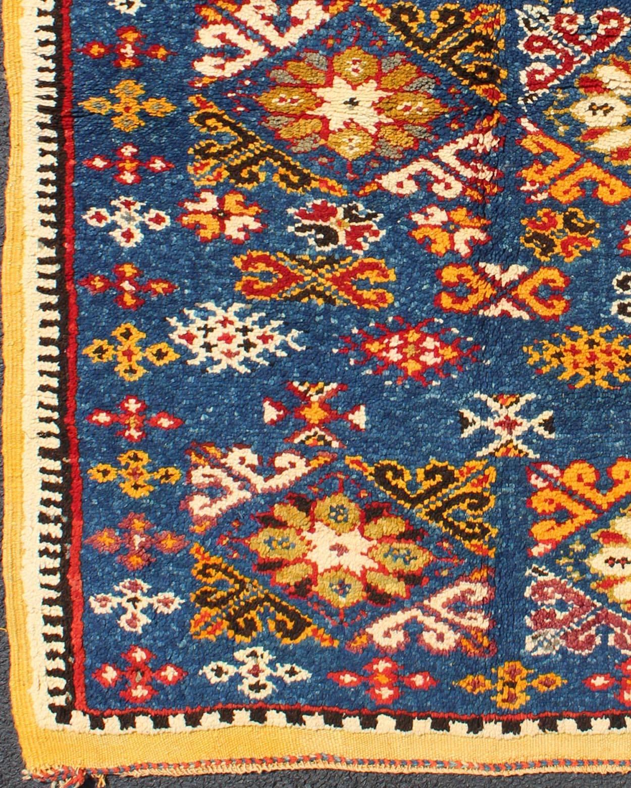 Vintage Moroccan rug with bright blue field and colorful geometric motifs, rug n15-0401, country of origin / type: Morocco / Tribal, circa 1980s

This gorgeous vintage Moroccan carpet from the late 20th century displays a stunning, all-over