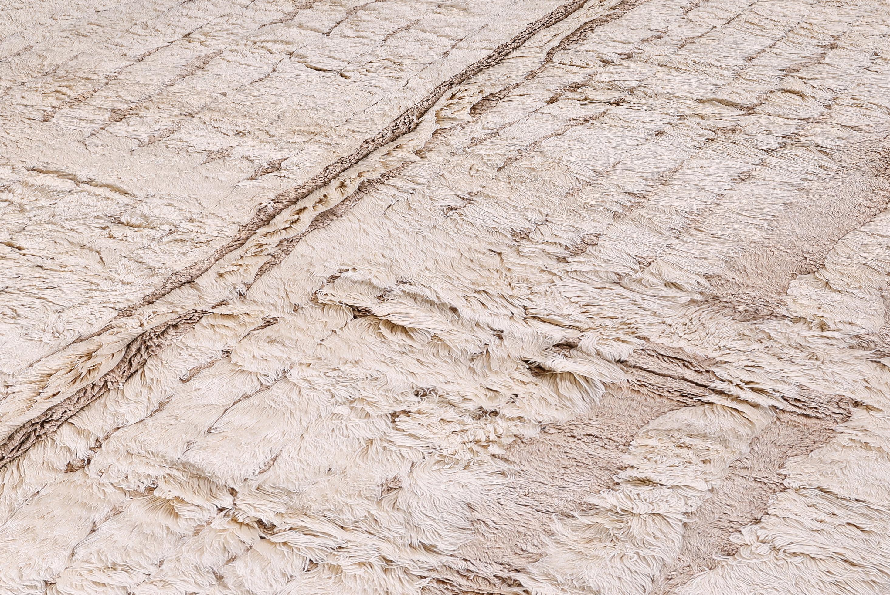 This contemporary Moroccan rug is a newly handwoven masterpiece, crafted from 100% premium wool for exceptional softness and durability. Showcasing a subtle geometric grid pattern in warm neutral tones, it brings understated elegance to modern and