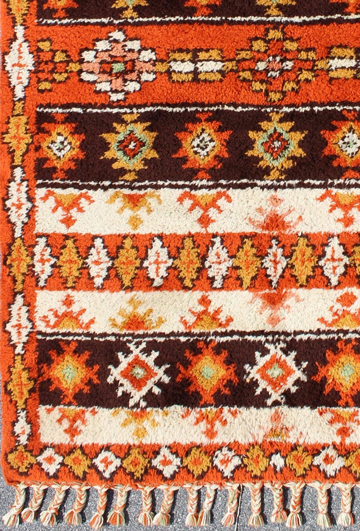 Vintage Moroccan Berber Rug, Keivan Woven Arts / rug 13-1202, country of origin / type: Morocco / Tribal, circa Late-20th Century.

Measures: 6' x 9'.

This colorful Vintage Moroccan rug, features a vibrant burnt orange, ivory, yellow and dark brown