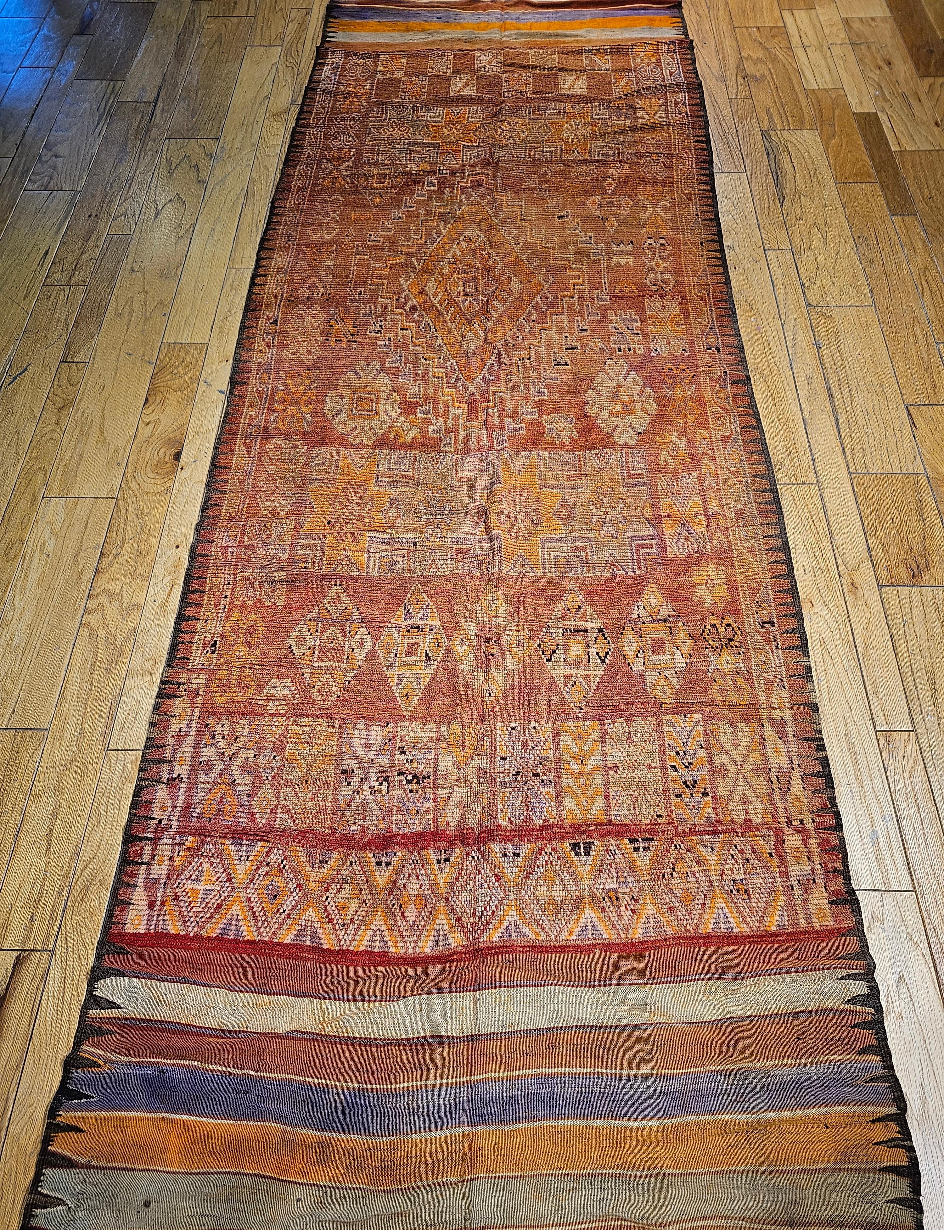 Vintage Moroccan Rabat gallery rug or a wide runner in a geometric pattern from the early 1900s.  Astonishing colors in the field and the border. A pale yellow provides the  background color for the geometric patterns in the field in shades of