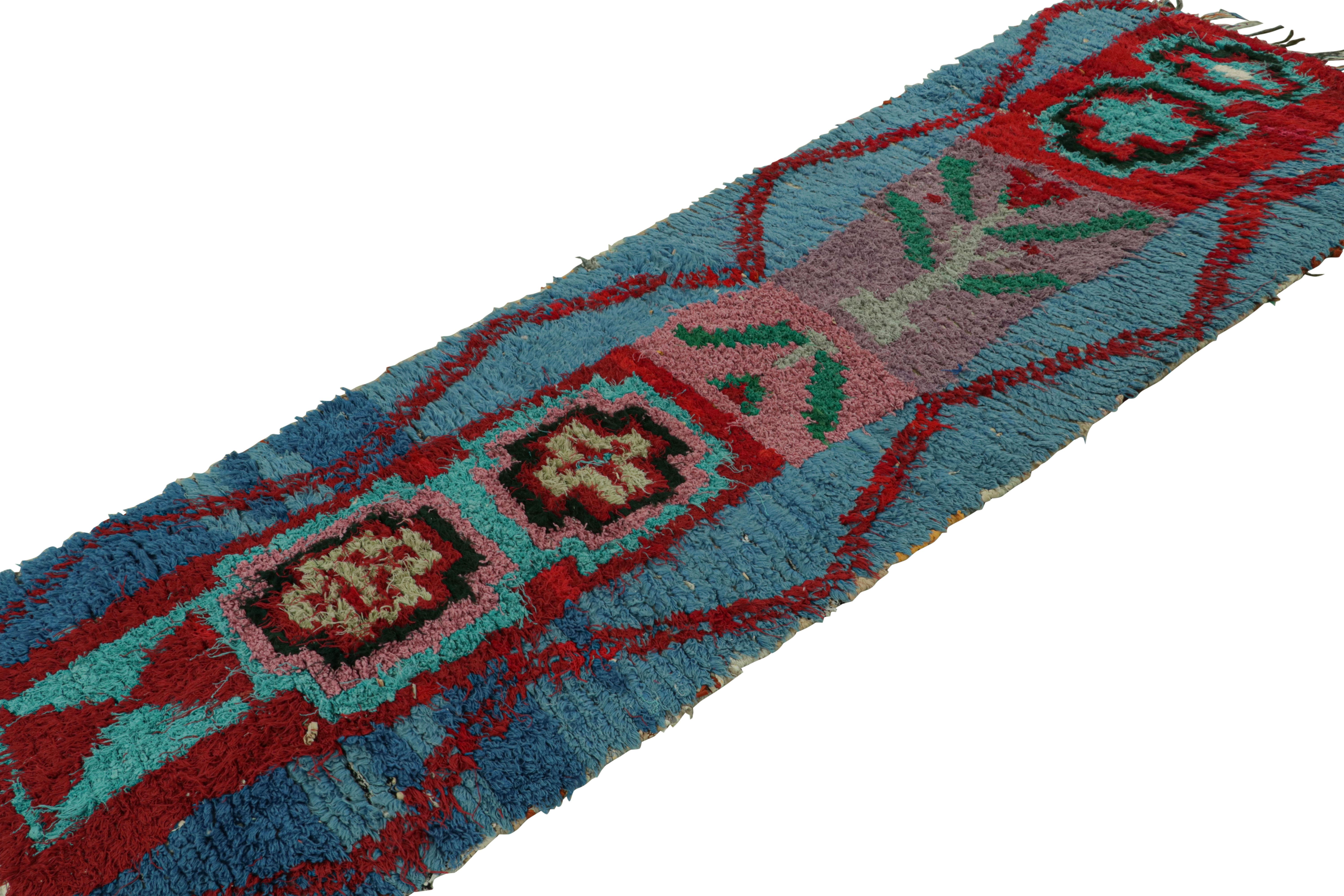 Hand-knotted in wool circa 1950-1960, this 3x9 vintage Moroccan runner rug is believed to hail from the Azilal tribe. 

On the Design: 

Ocean blue tones underscore geometric patterns in rich burgundy red and pink, with other playful accents in