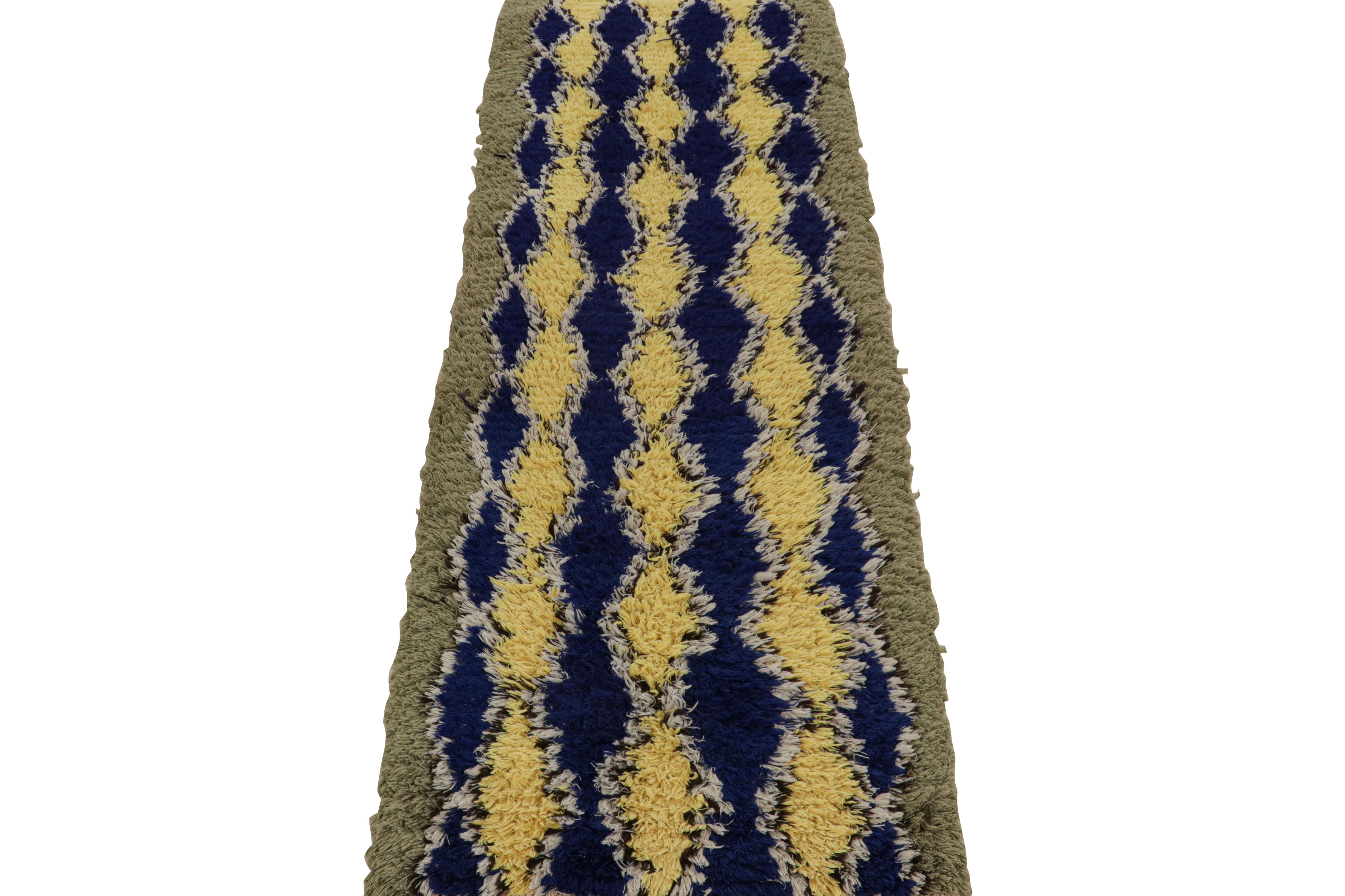 Hand-knotted in wool circa 1950-1960, this 2x8 vintage Moroccan runner rug with diamond geometric patterns on a navy blue field, hails from the Azilal tribe.  

On the Design: 

Connoisseurs will further admire this as an exemplary piece of the